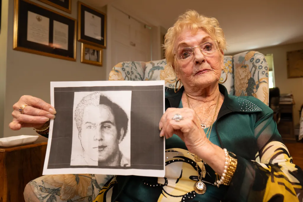 Wendy Savino of Congers, NY, holds up a composite image of a man's face.