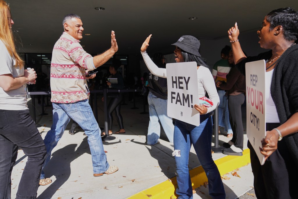 People high-fiving the welcome team at 2819 Church.