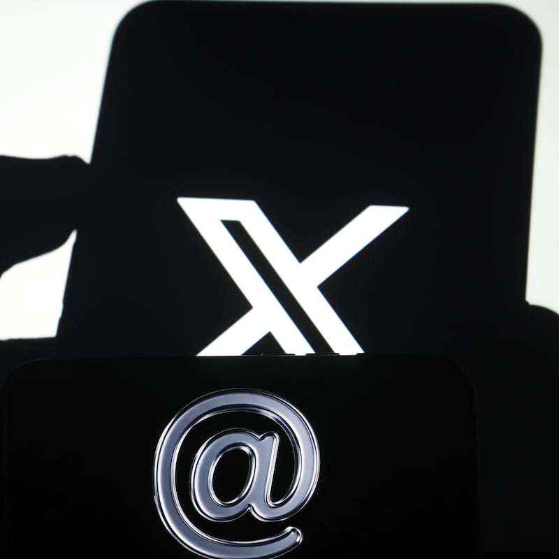 ANKARA, TURKIYE - NOVEMBER 6: In this photo illustration X logo is displayed on a mobile phone screen with an '@' sign blurred in the background in Ankara, Turkiye on November 6, 2025. (Photo by Metin Aktas/Anadolu via Getty Images)