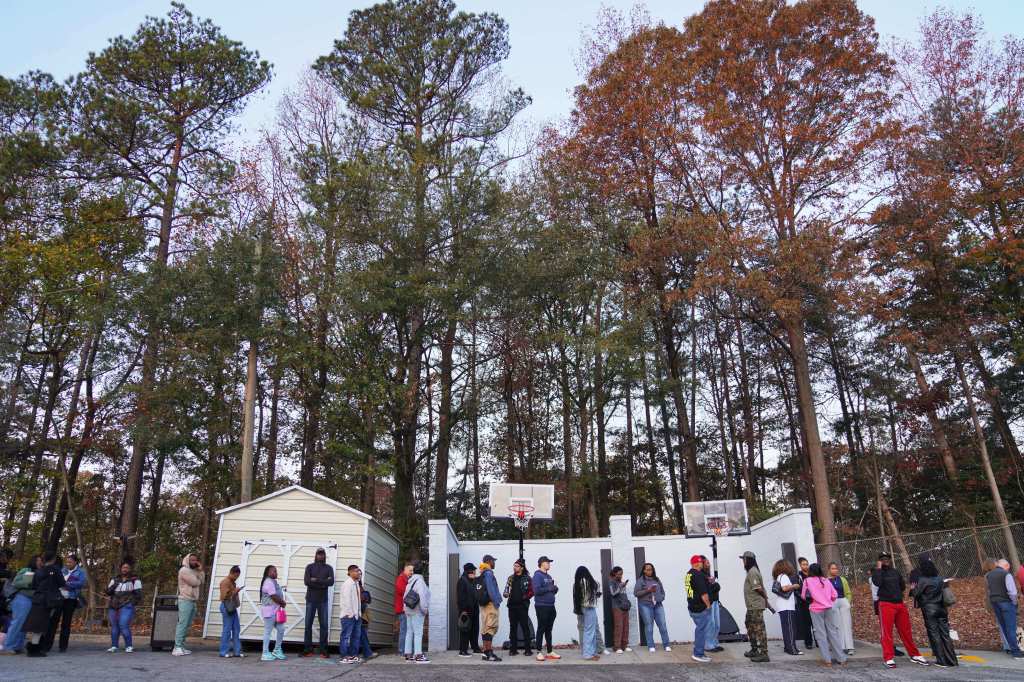 People wait in line for a church service.