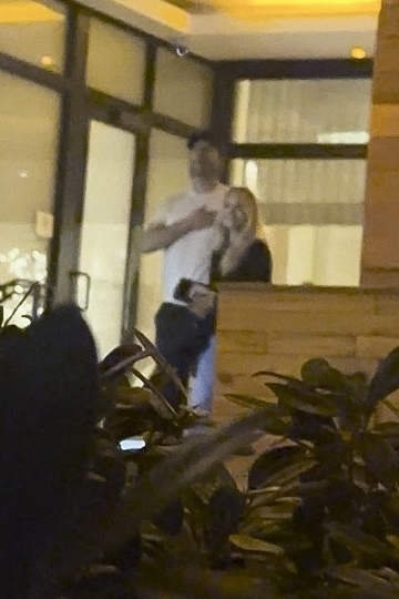 Glen Powell and Michelle Randolph returning to their hotel in Miami.