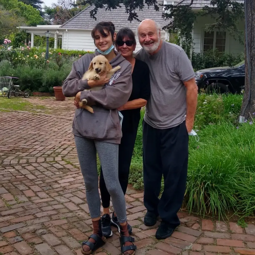 Romy, Michele, and Rob Reiner with a puppy 
