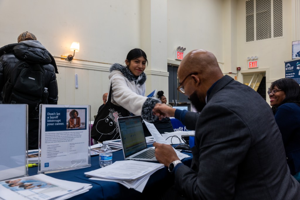 Job seekers attend a career fair.