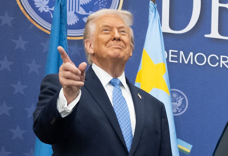 President Donald Trump gestures before a signing ceremony of a peace deal at the Institute of Peace on December 4, 2025.