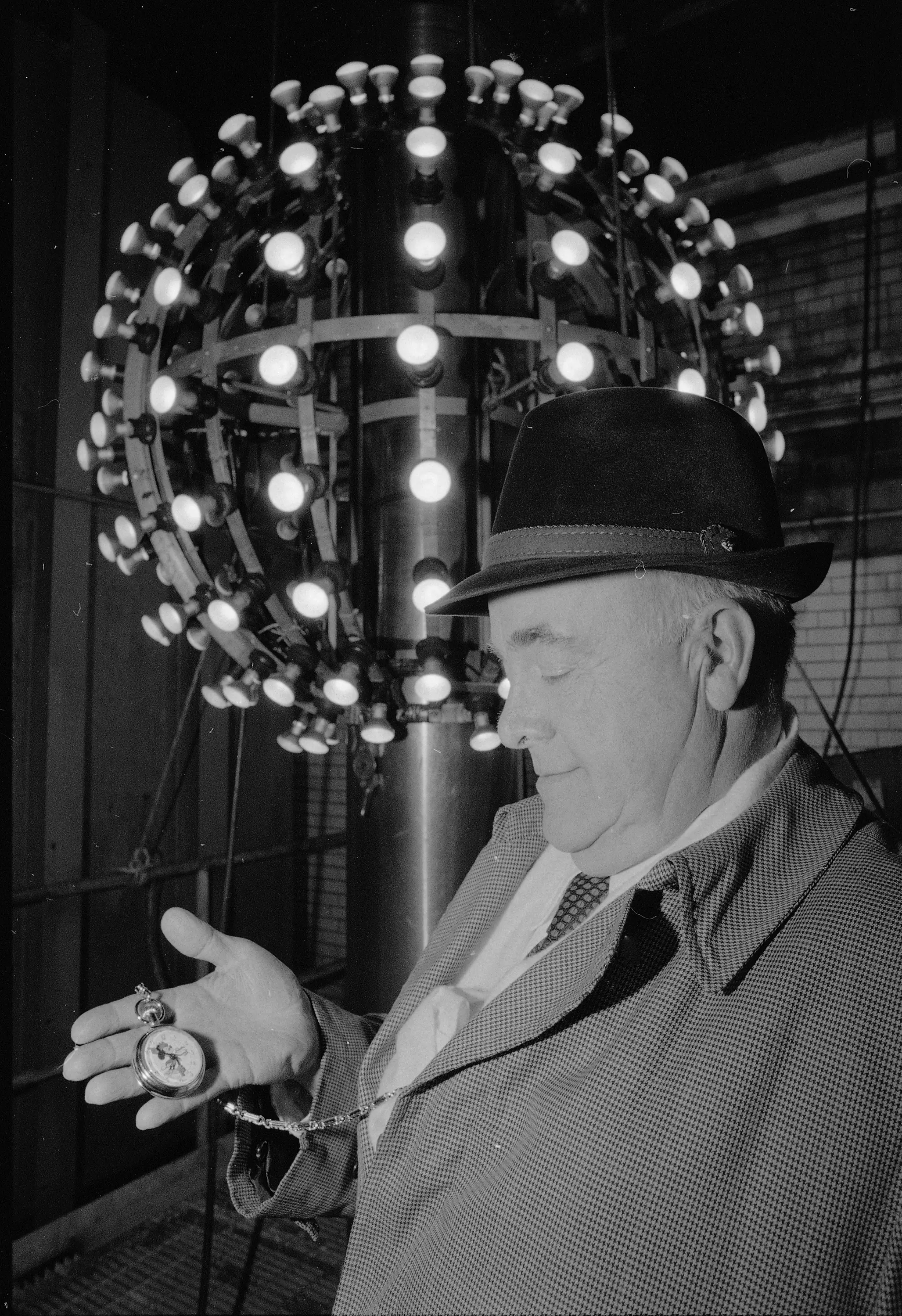 Superintendent of One Times Square Russ Brown checks his watch with the Times Square ball illuminated in the background in 1980.