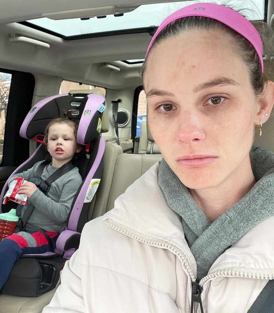 Meghan King in a car with her child in a car seat.