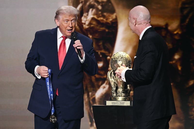 President Donald Trump speaks as he receives the inaugural FIFA Peace Prize alongside FIFA President Gianni Infantino during the draw for the 2026 FIFA Football World Cup in Washington, DC, on December 5, 2025.