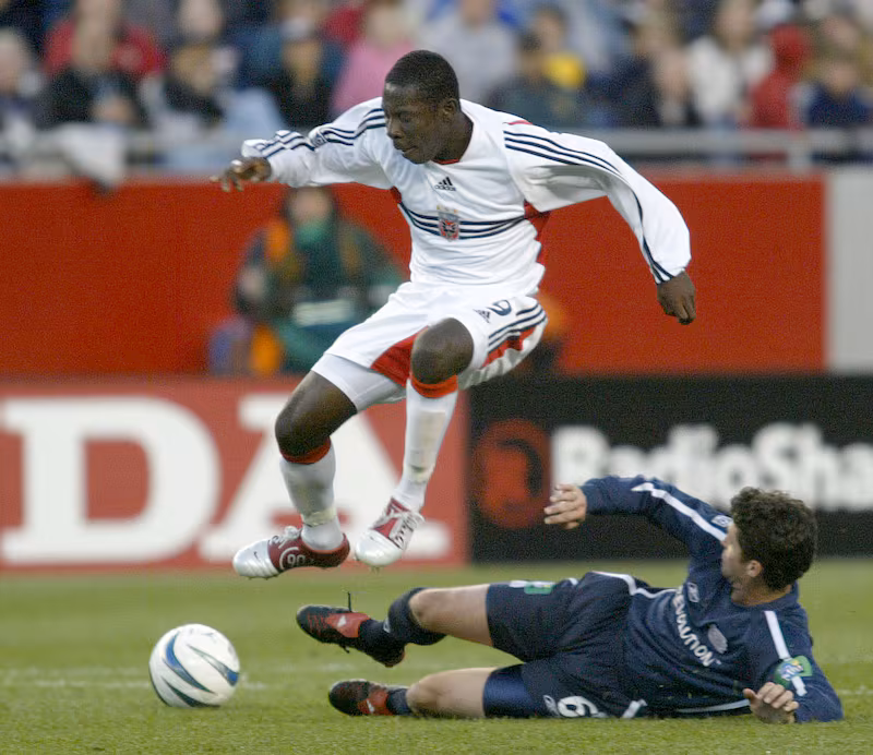 DC United forward Freddy Adu jumps over New England Revolution defender Jay Heaps during the first half of the game at Gillette Stadium in Foxboro, Massachusetts, Saturday, May 29, 2004.