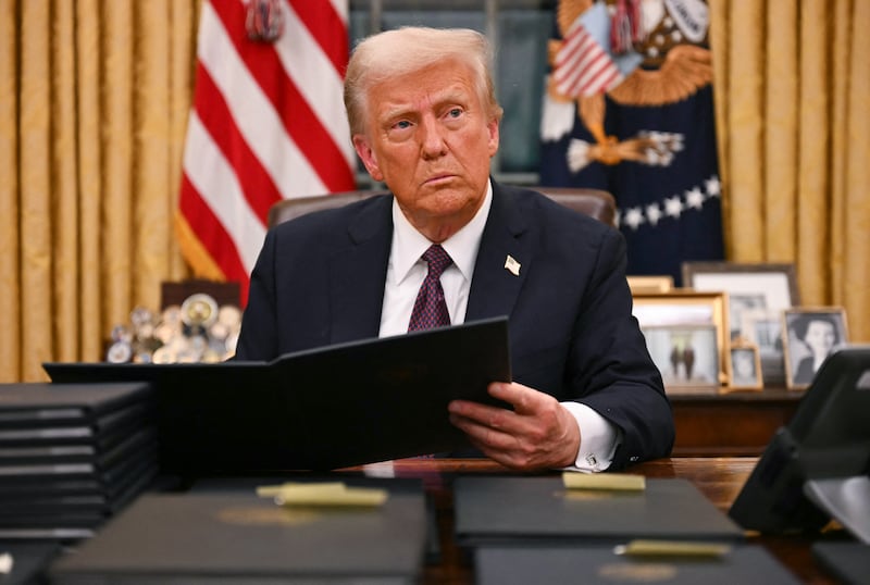 TOPSHOT - US President Donald Trump signs an executive order for pardons on January 6 offenders in the Oval Office of the WHite House in Washington, DC, on January 20, 2025. (Photo by Jim WATSON / AFP) (Photo by JIM WATSON/AFP via Getty Images)