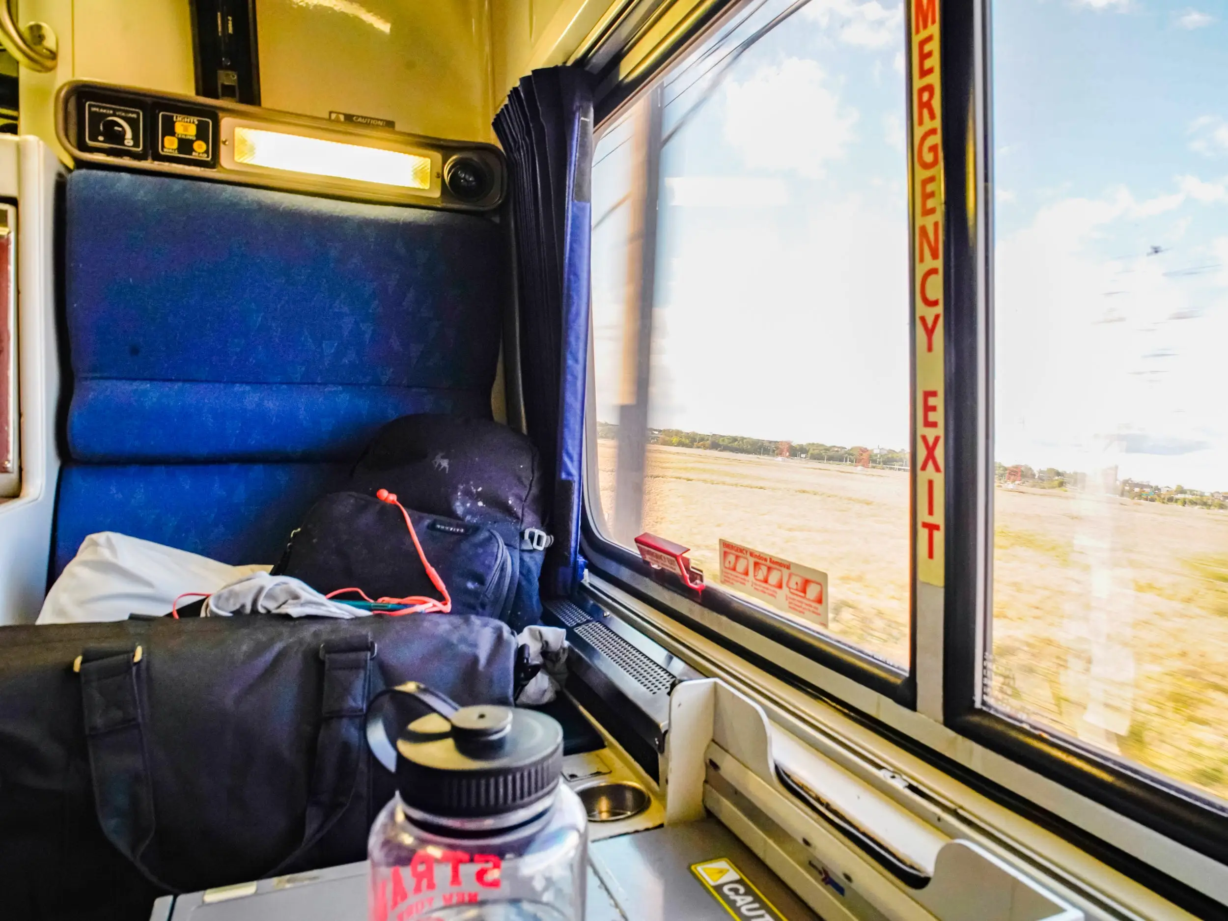 A view of the window on the right and a chair on the left in the roomette