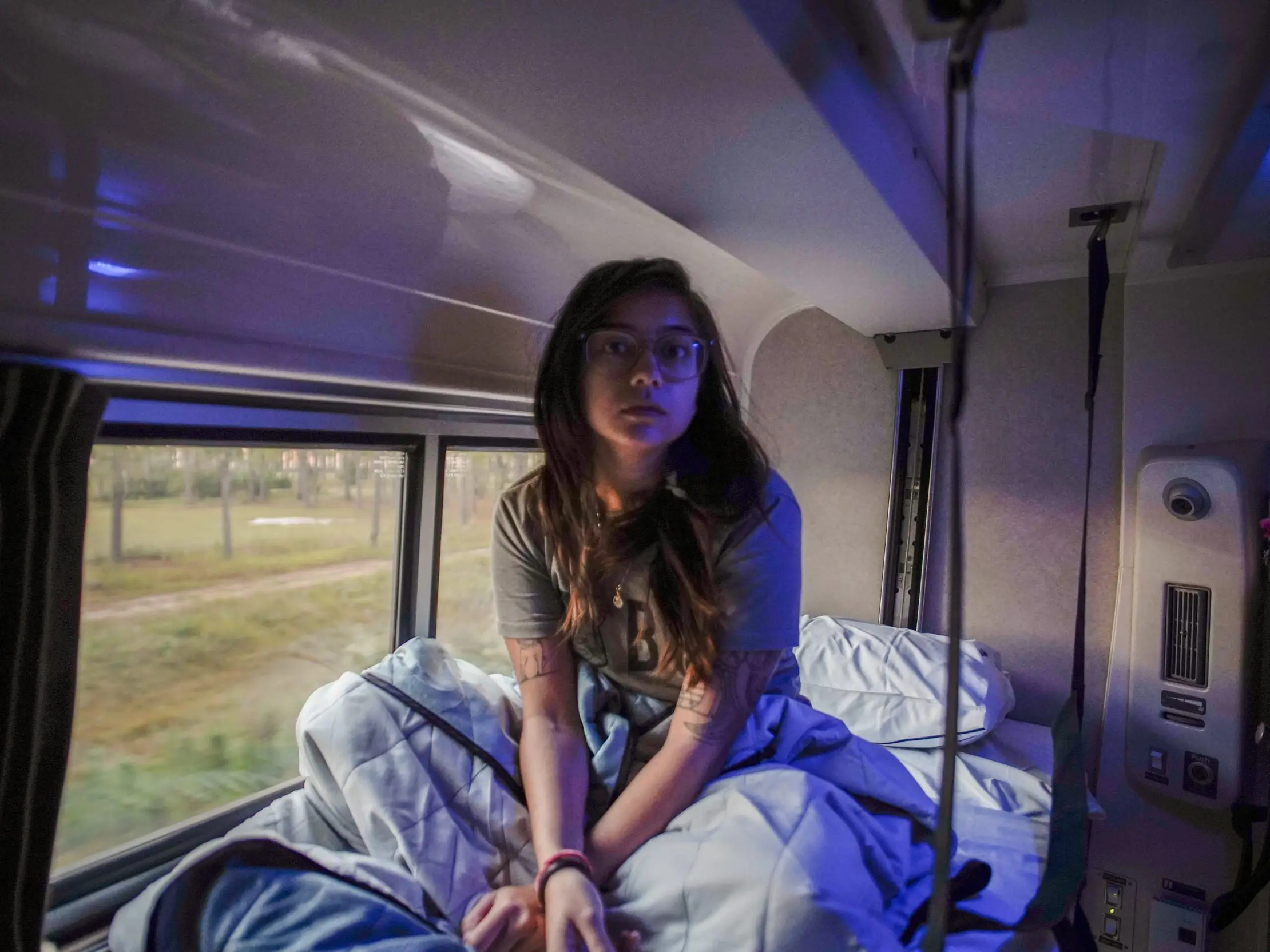 The author sits in her bed on the Amtrak train