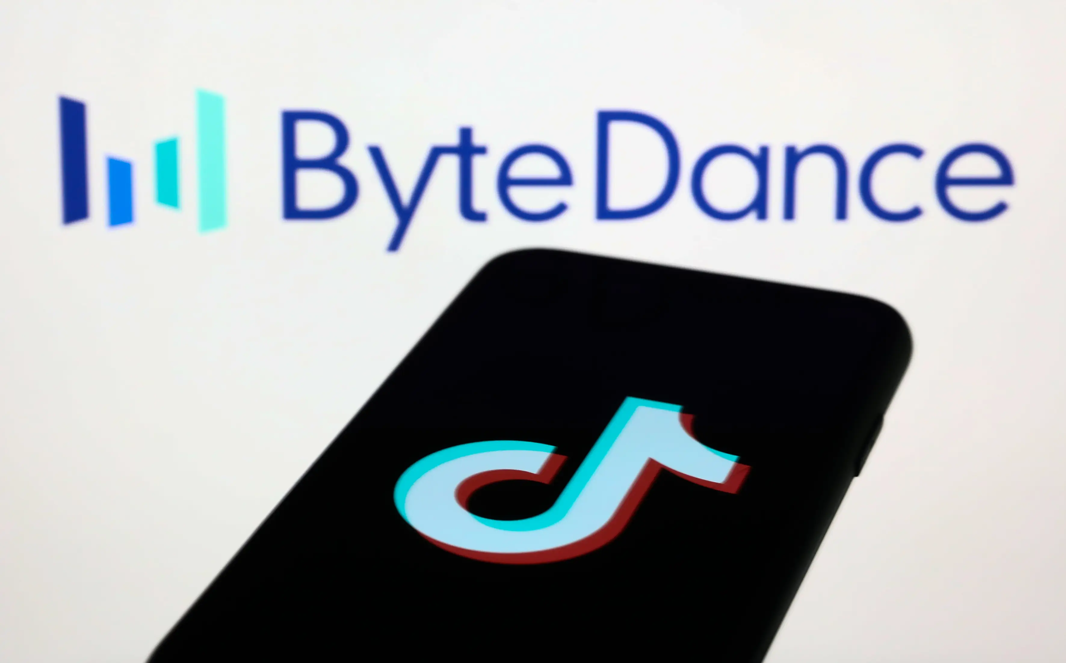 ByteDance logo displayed on a screen and TikTok logo displayed on a phone screen