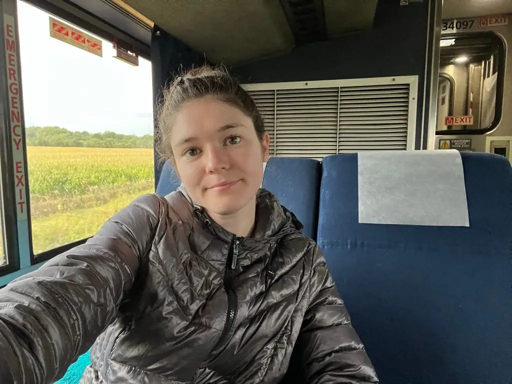 diana wearing a jacket while riding on an amtrak train