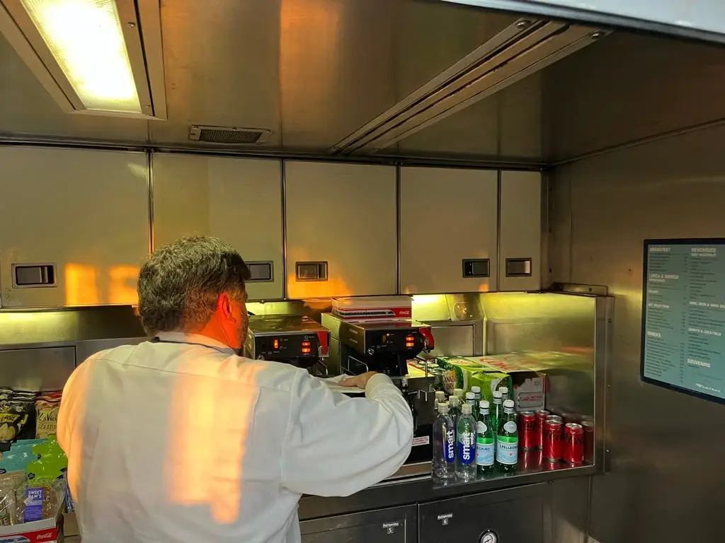 someone standing in the cafe car area on an amtrak train
