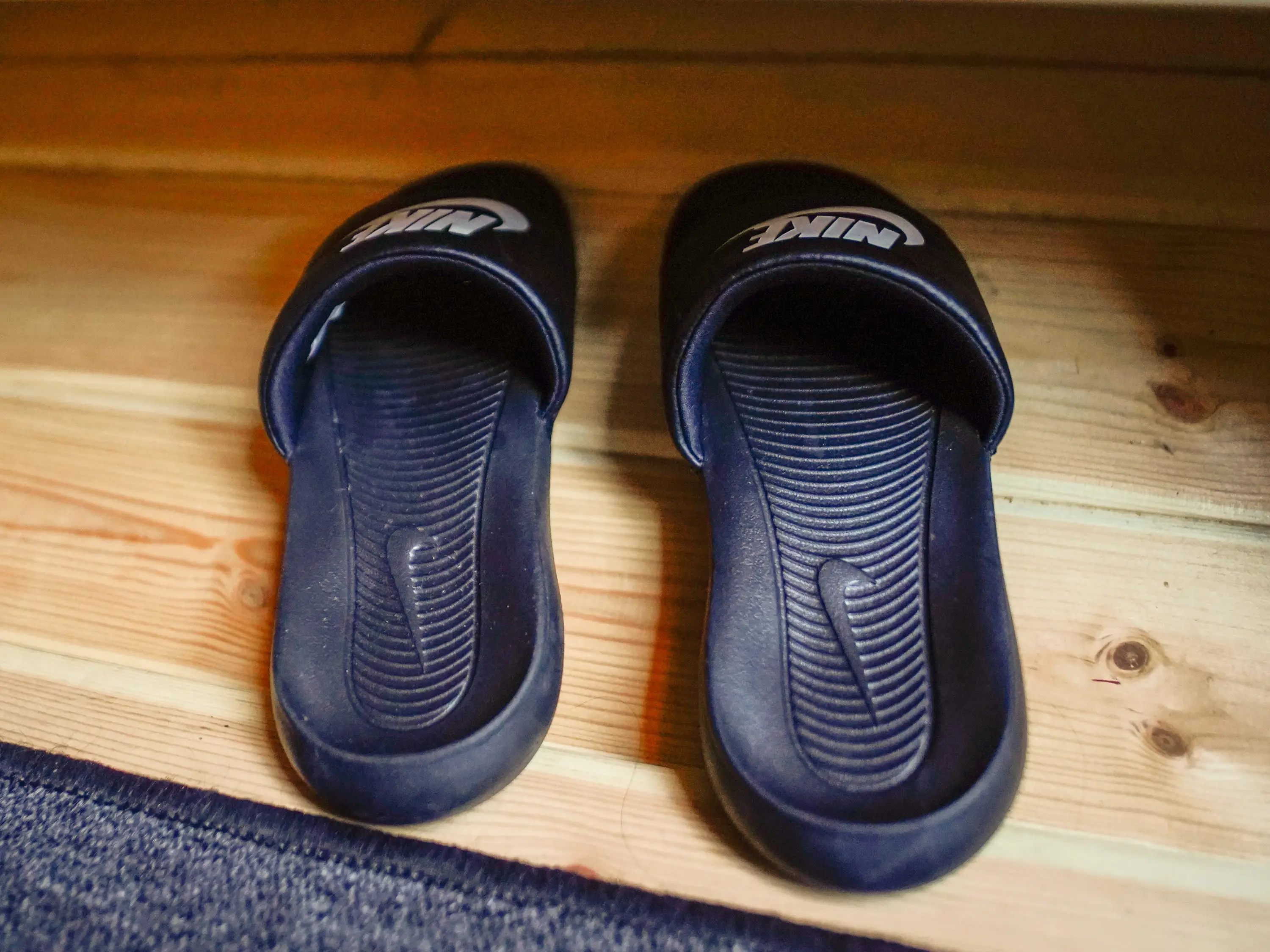 Nike slides on a wooden shelf