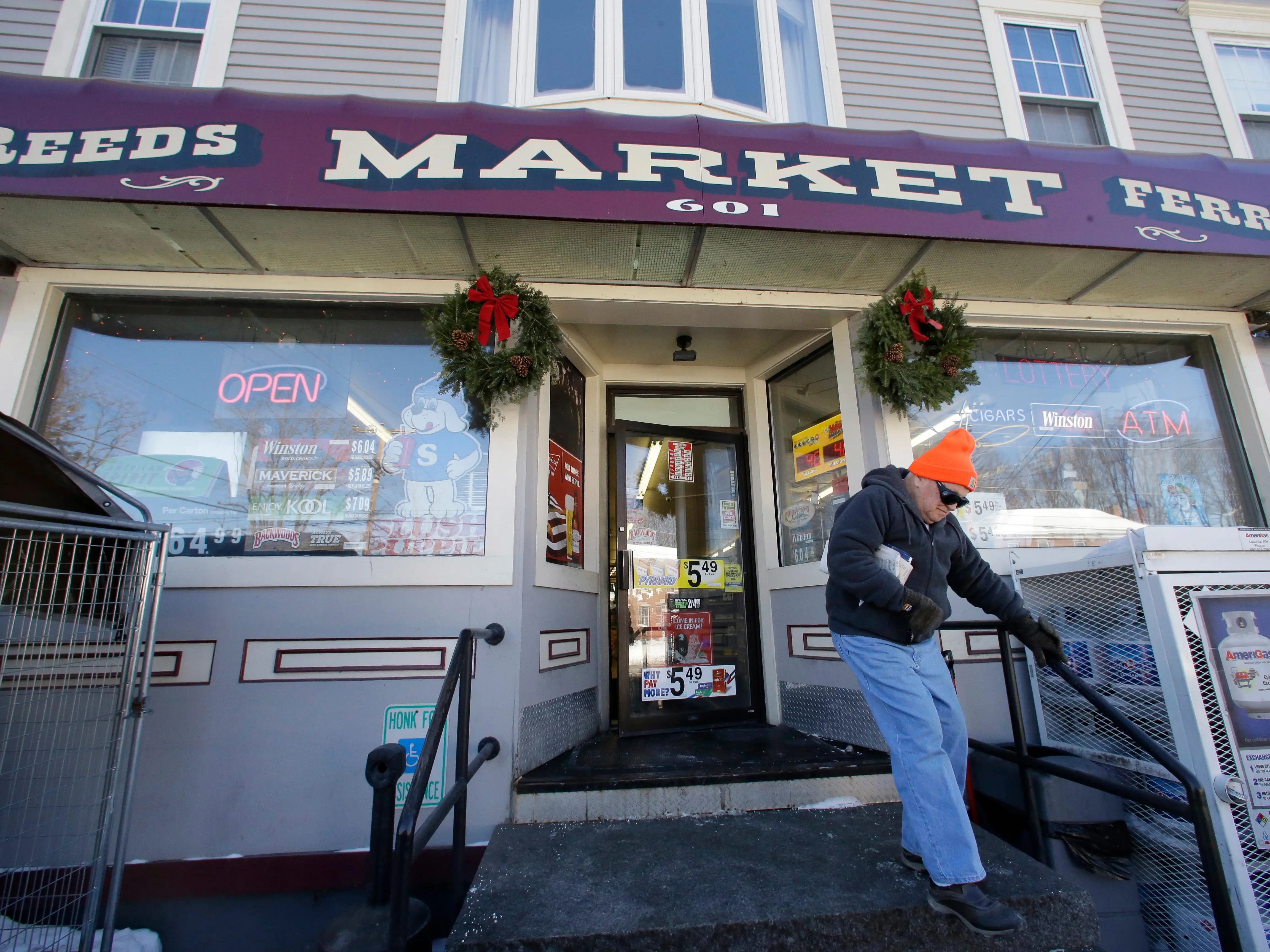 A customer departs Reeds Ferry Market convenience store on January 7, 2018, in Merrimack, New Hampshire, the location that sold the winning ticket