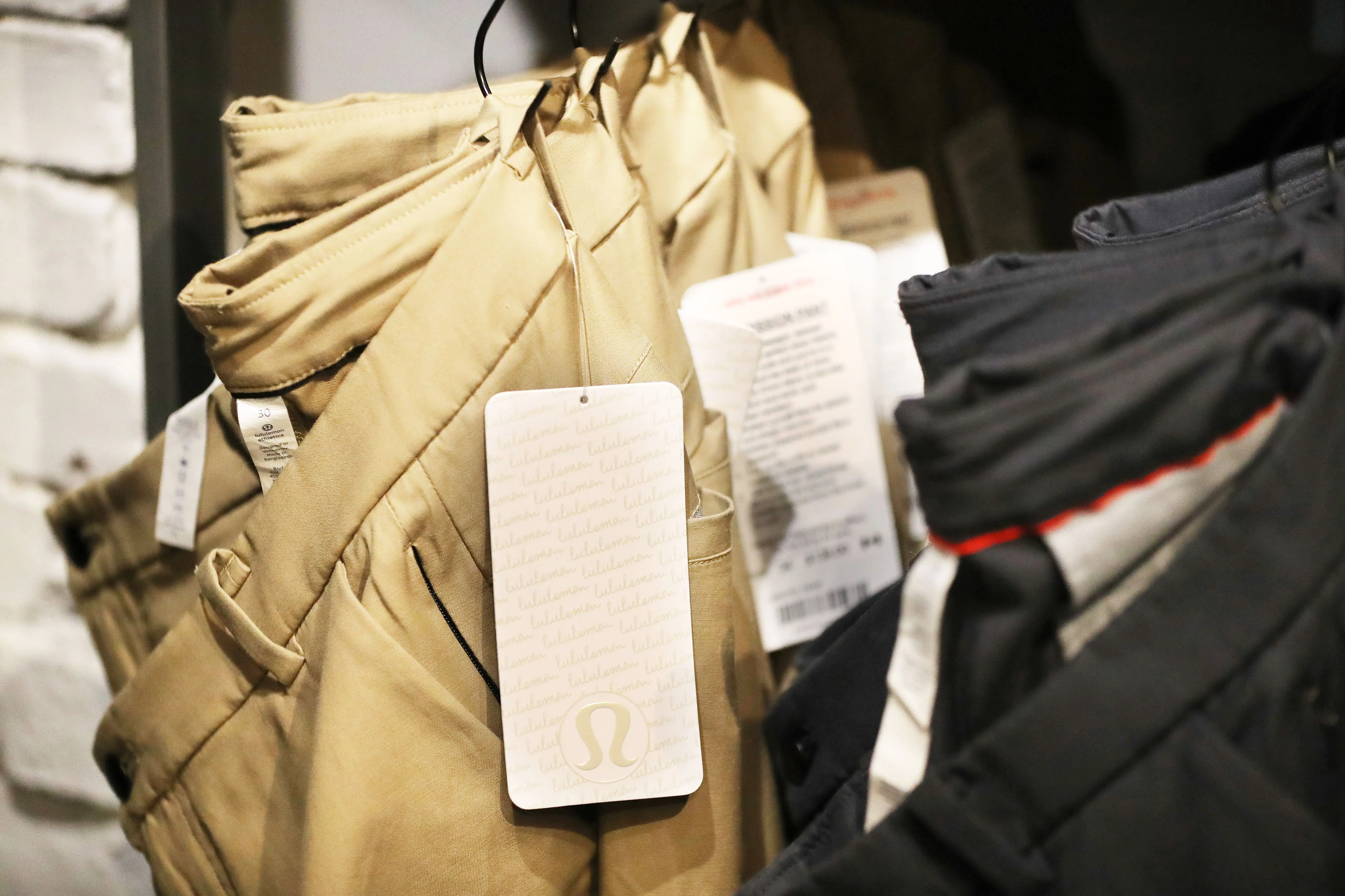 pairs of Lululemon pants hanging