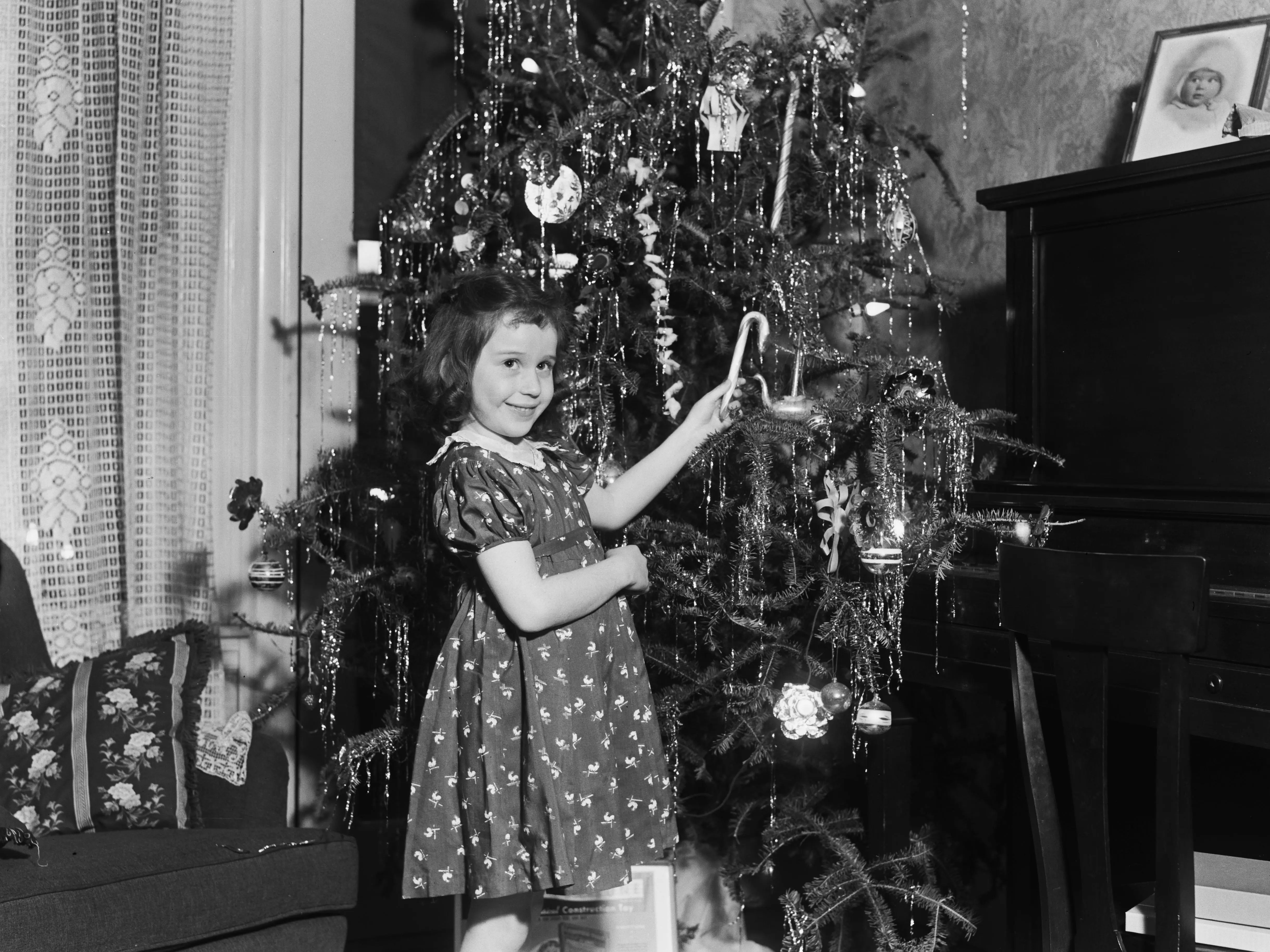 A young girl helps to decorate a Christmas tree in Newton, Massachusetts, in December 1939.