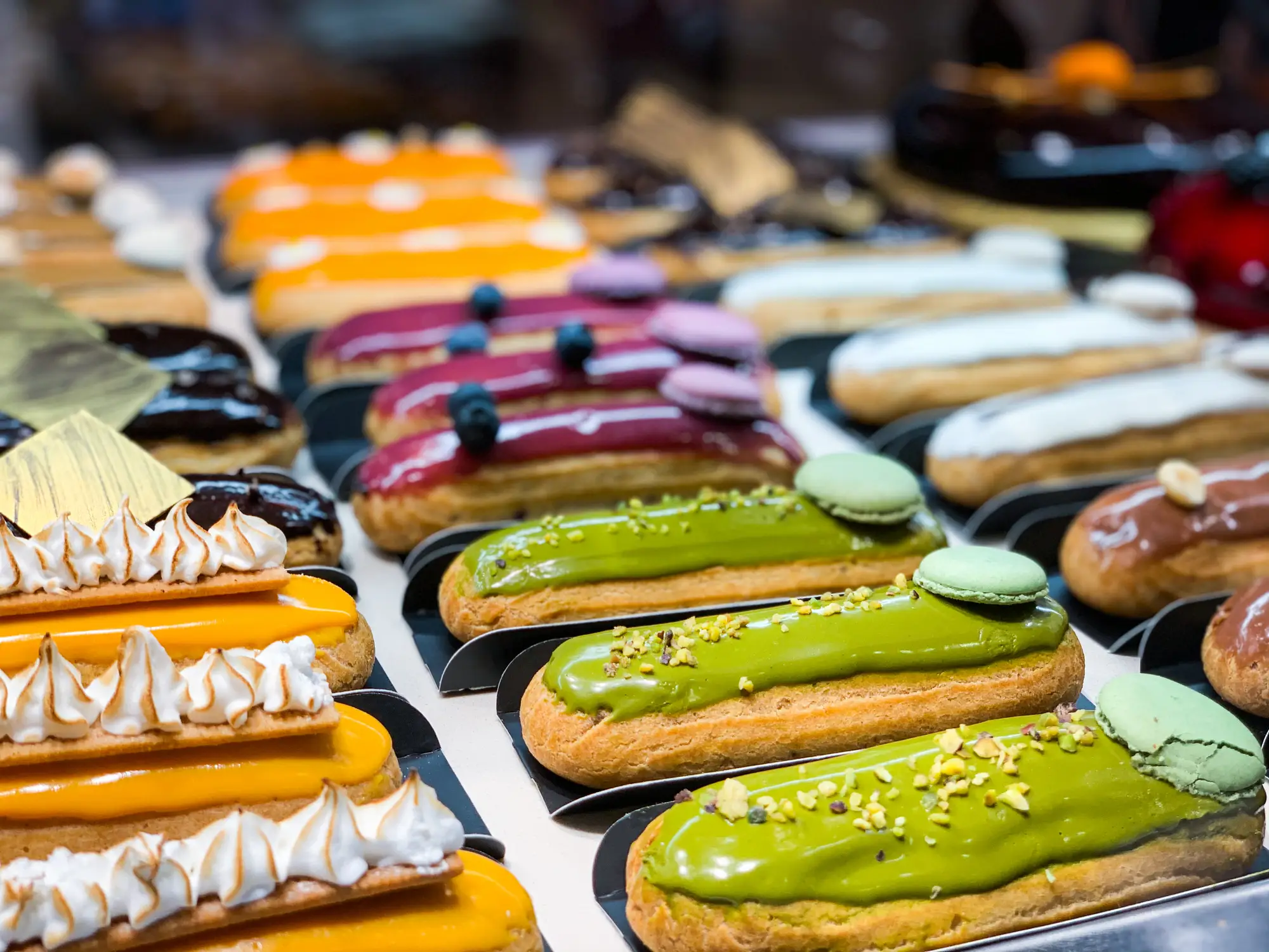 Colorful eclairs in display case