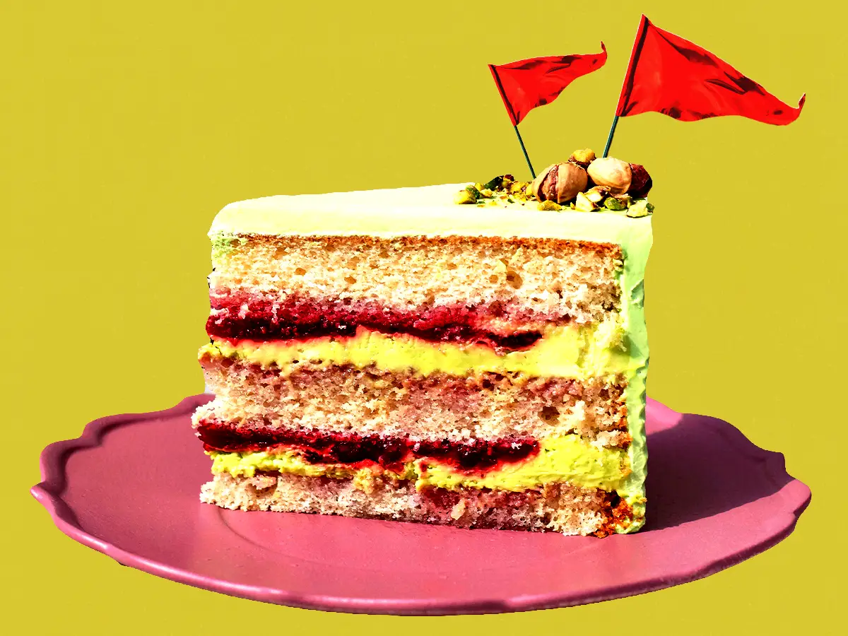 A graphic of a layered cake with two red flags sticking out of the top of it.
