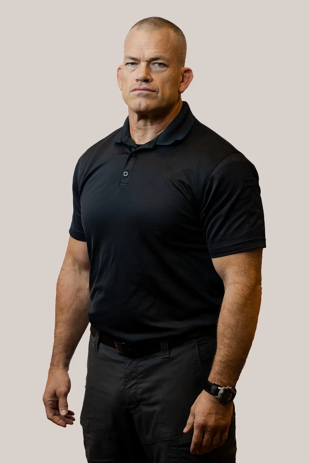 Jocko Willink in black dress pants and a collared shirt.