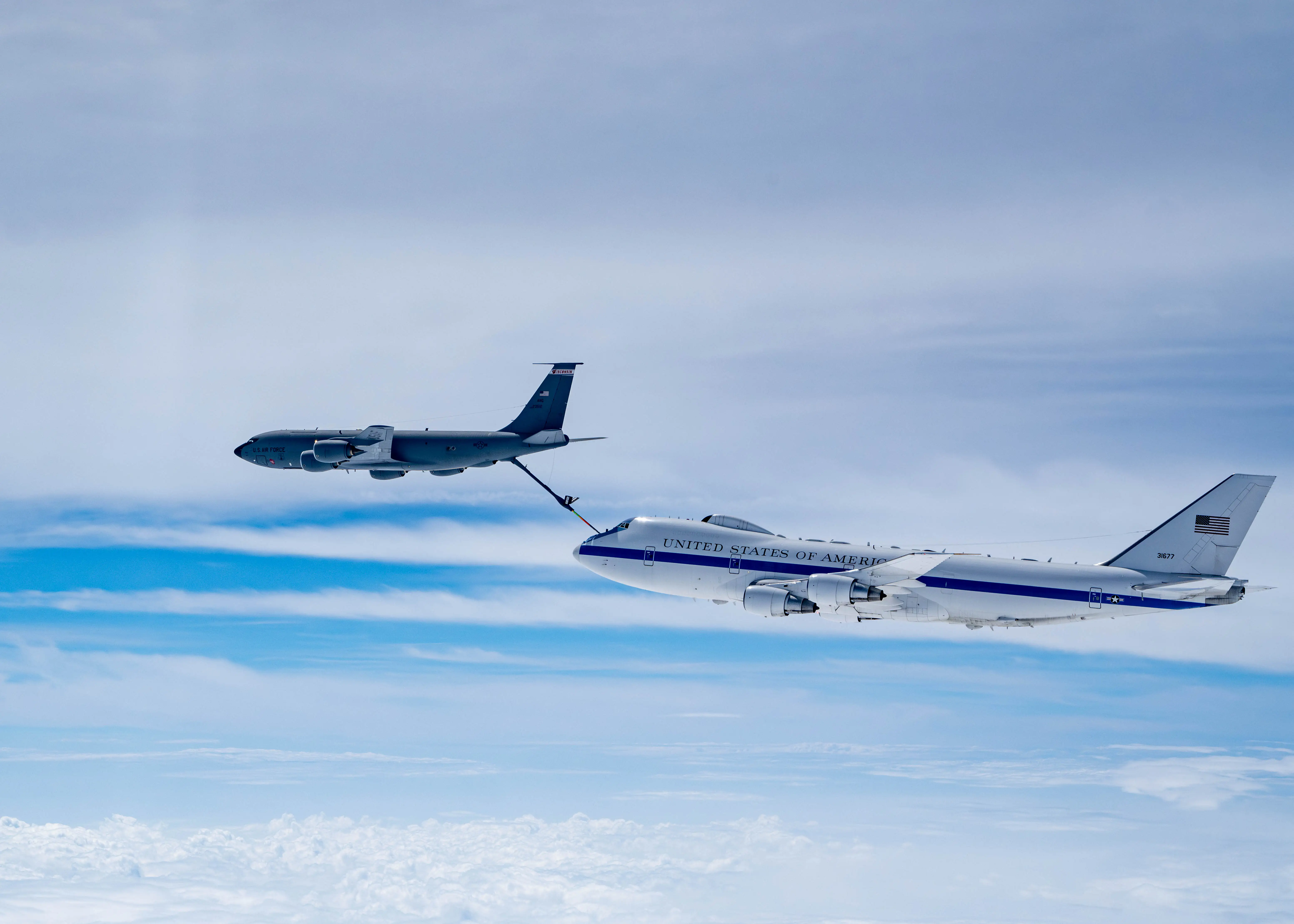 An E-4B plane is refueled in flight.