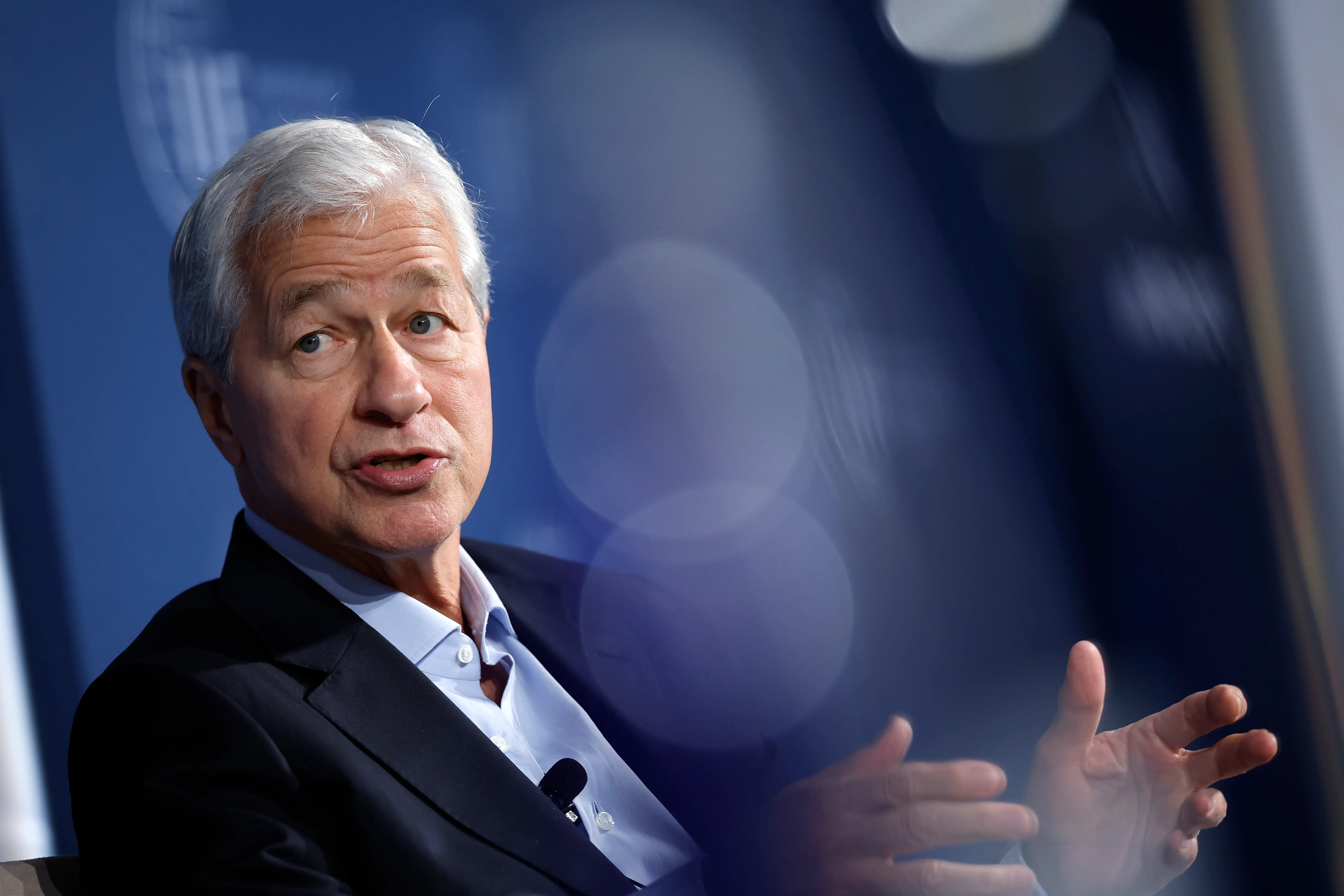 Jamie Dimon speaking and gesturing with his hands.