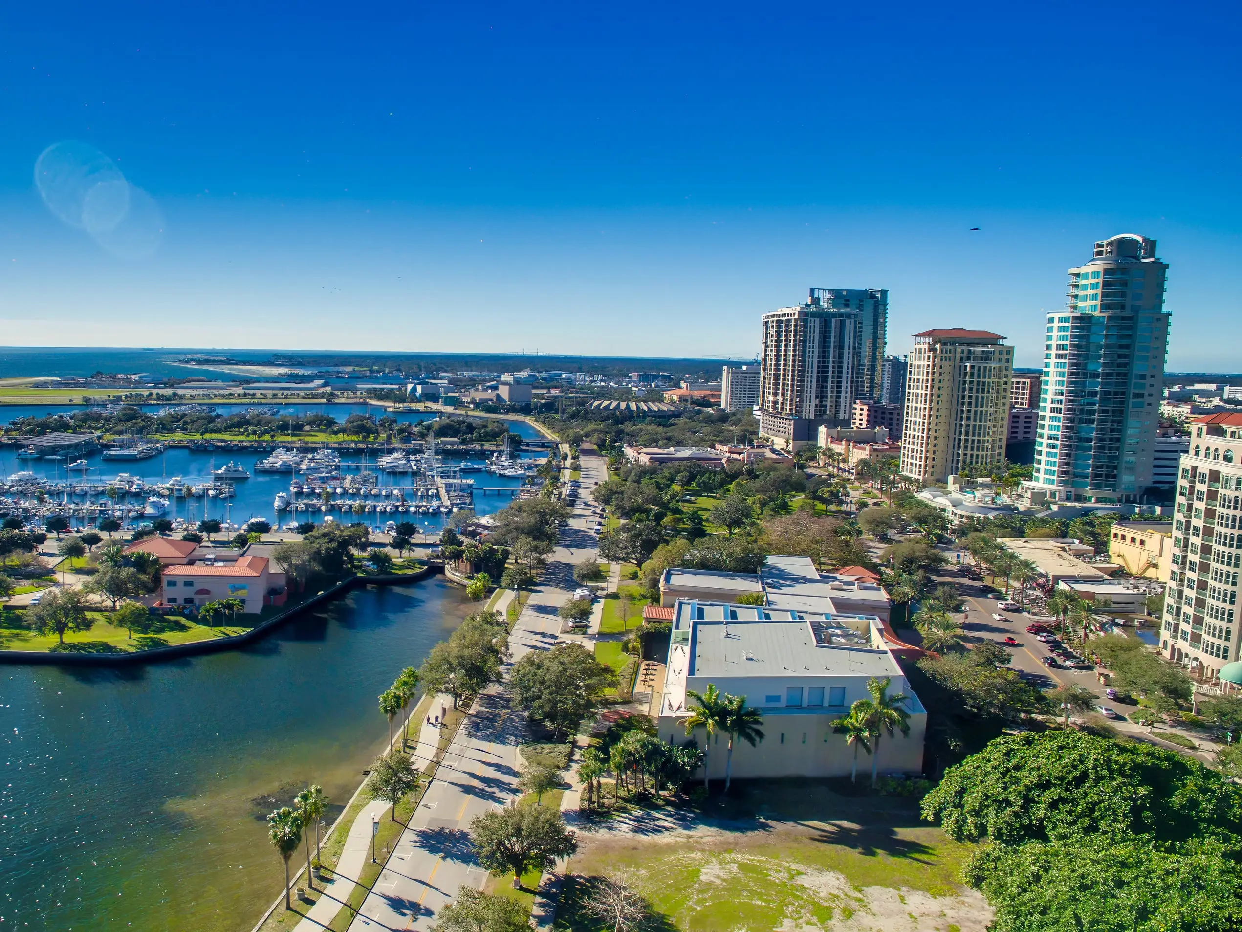 An aerial view of St Petersburg, Florida, with buildings next to a bay.