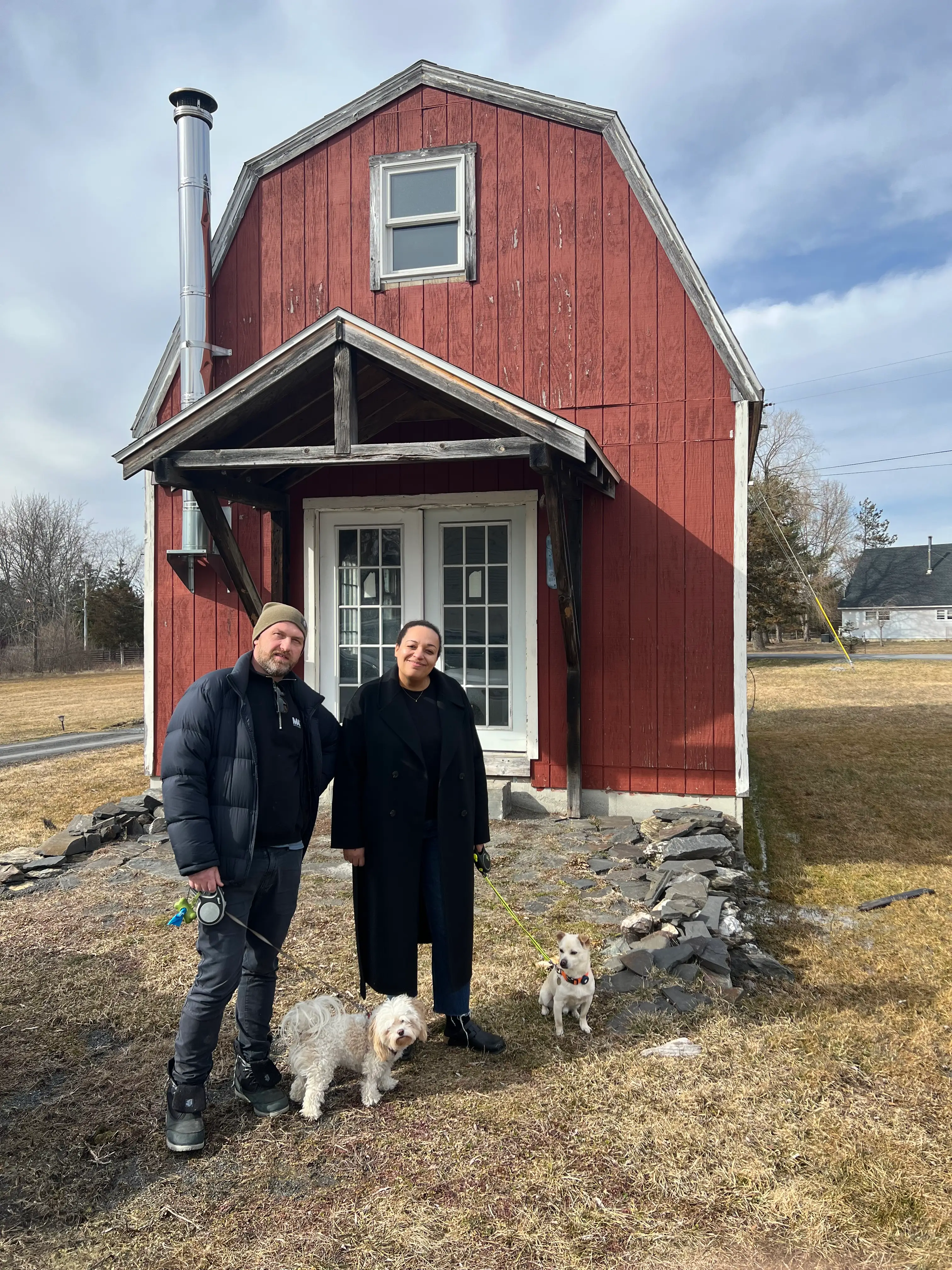 Wade and Selena Lounds standing in front of their barn.