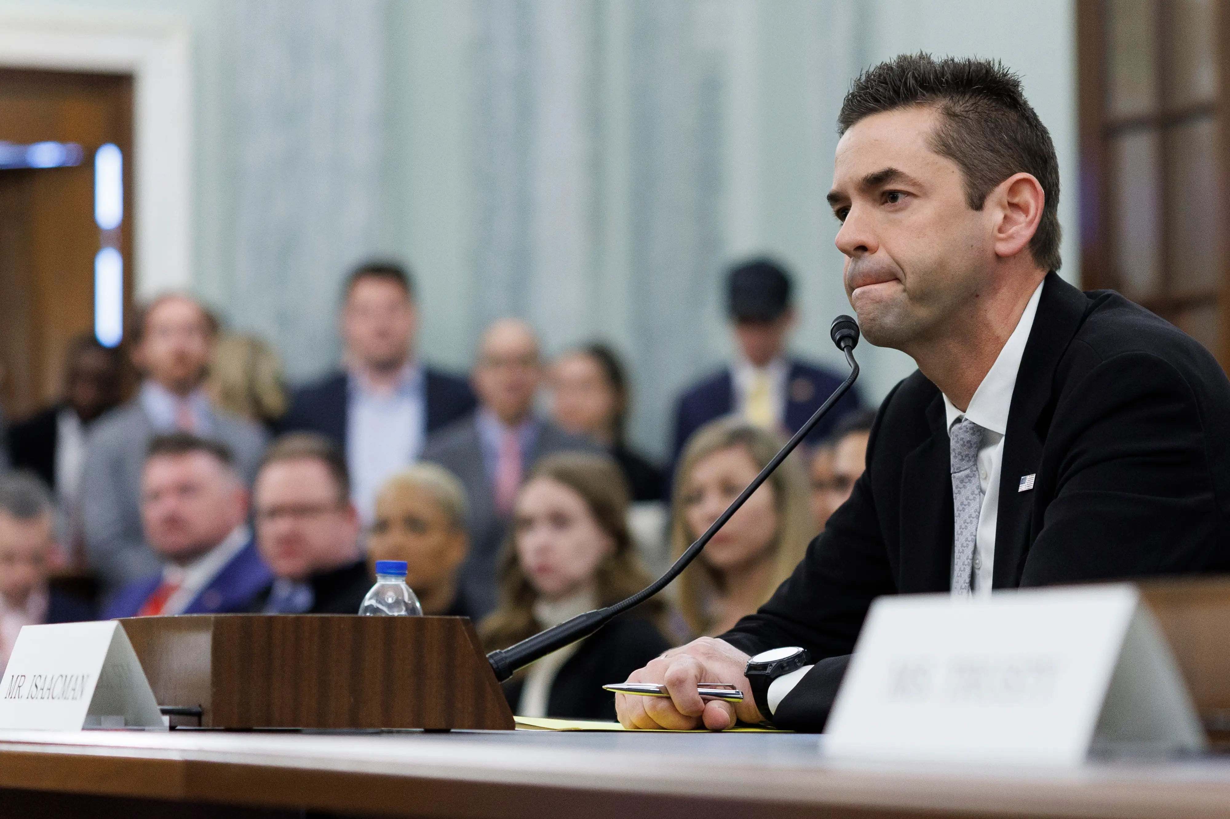 Jared Isaacman sitting with mic
