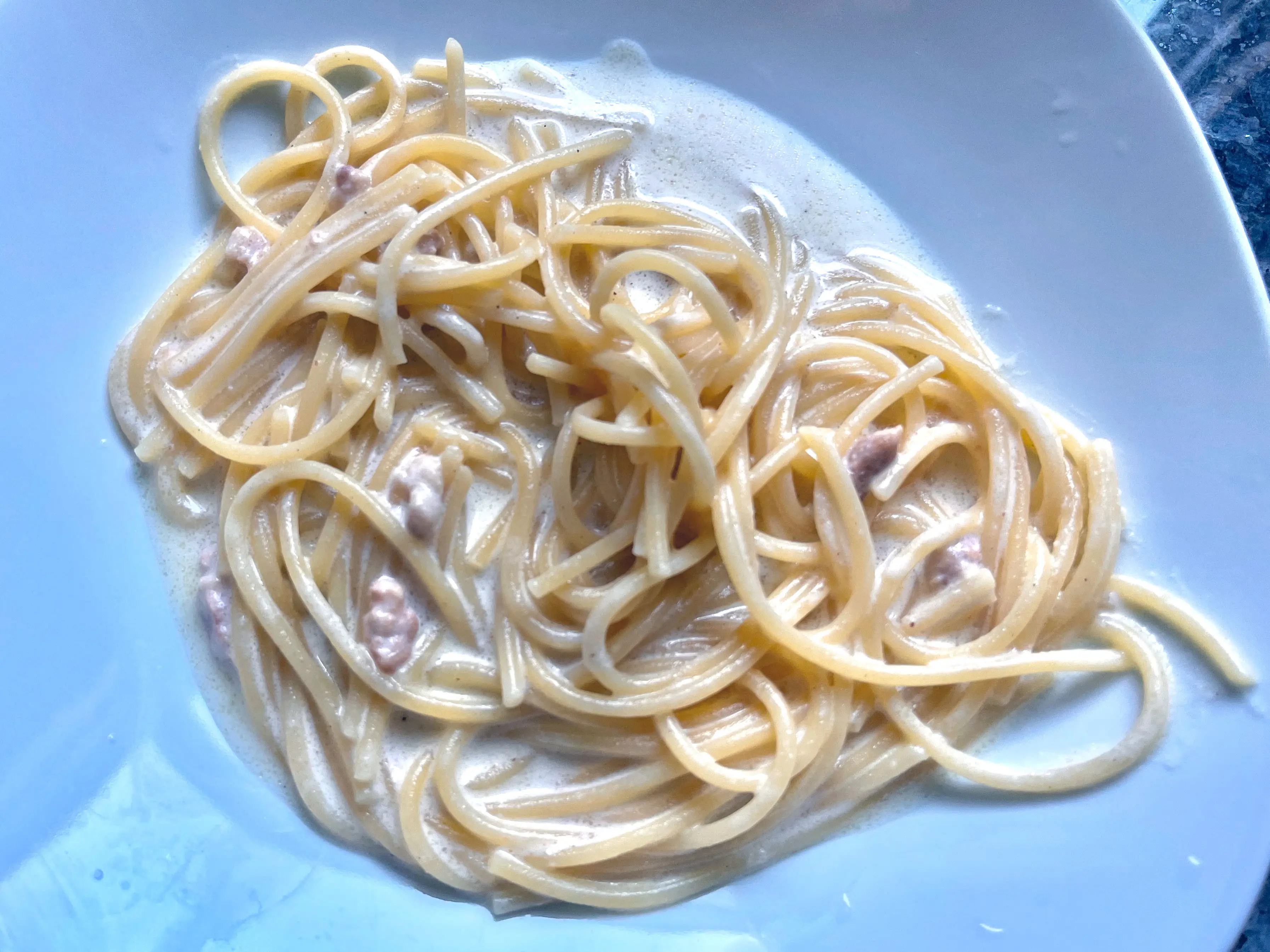 A plate of spaghetti carbonara.