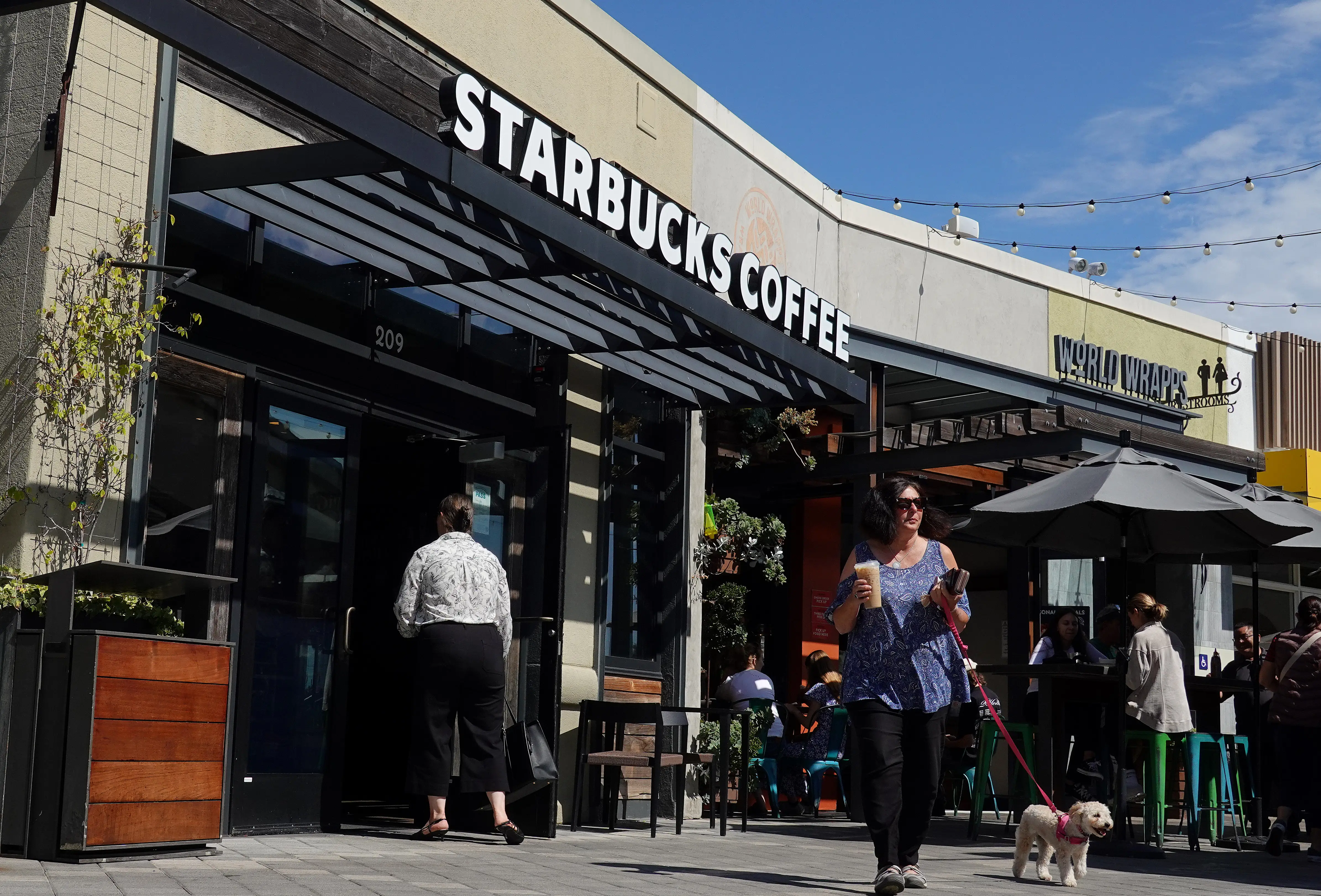 Customers leave a Starbucks Coffee shop on September 25, 2025 in Corte Madera, California.