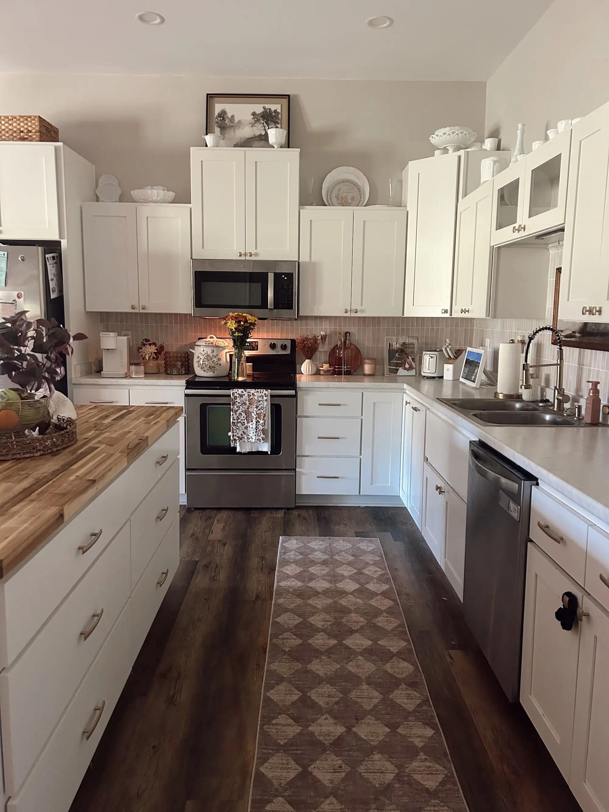 A kitchen with white countertops and cabinets.