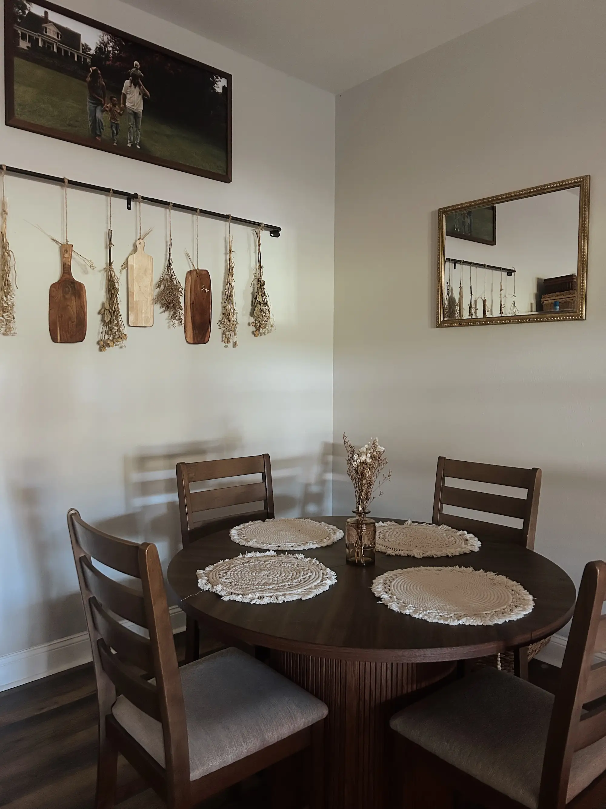 A round dining table sits in the corner of a room.