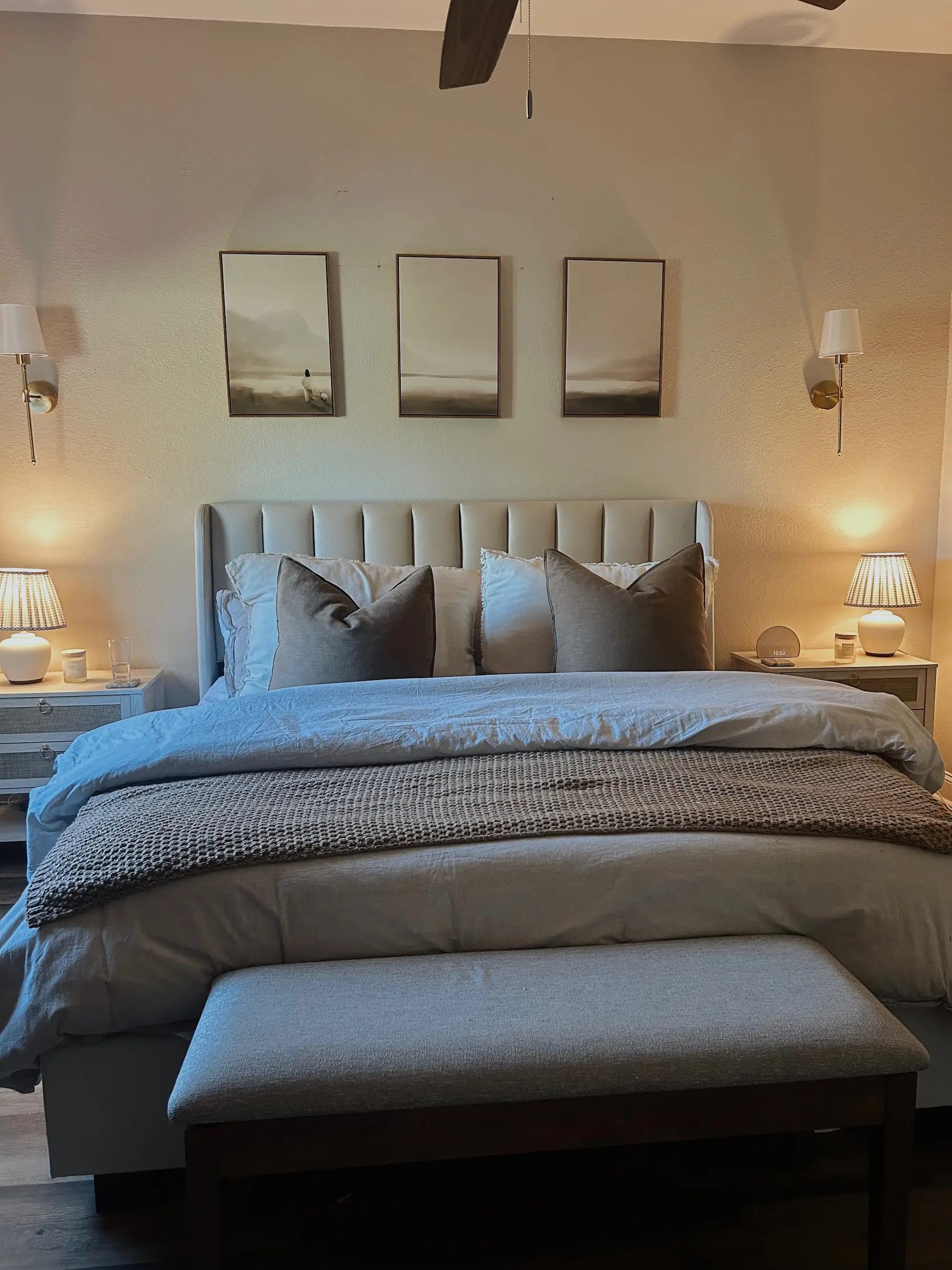 A large bed sits against a wall with a nightstand on either side.