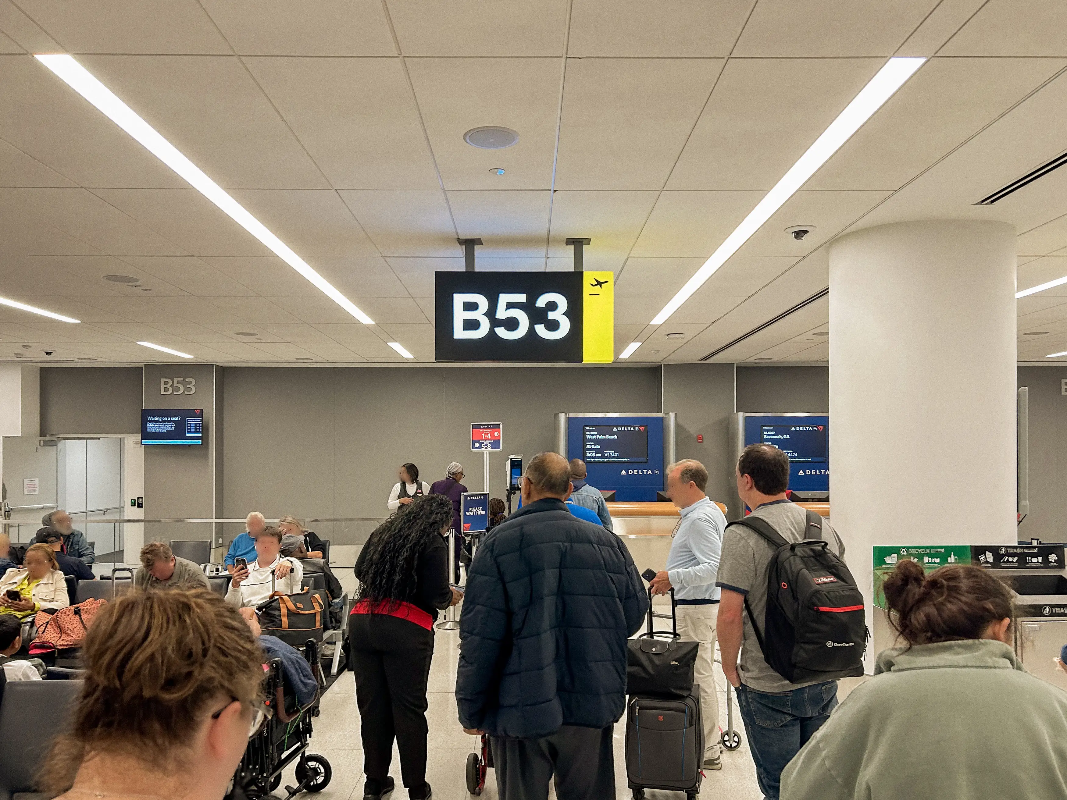Travelers line up to board at a Delta gate