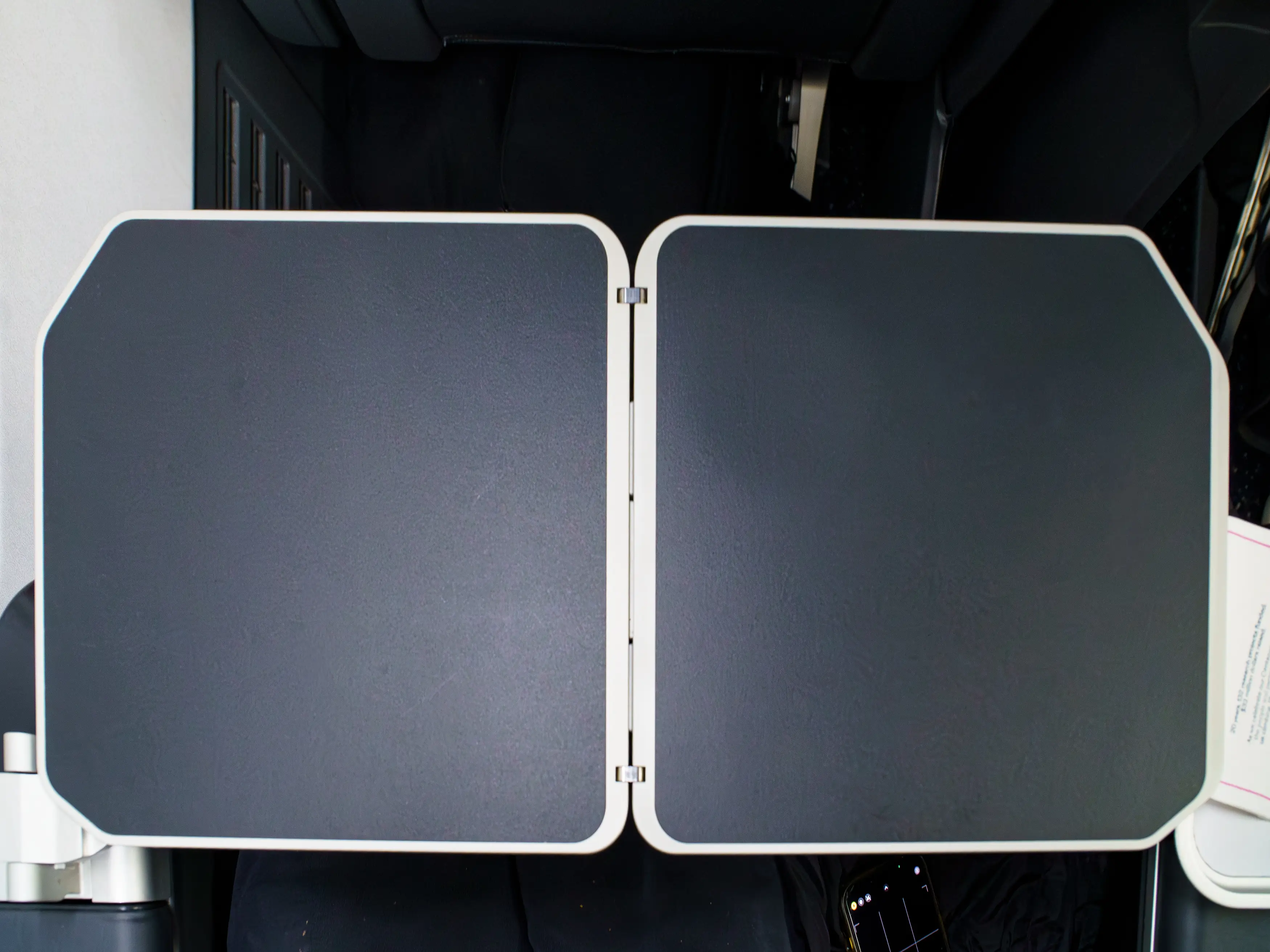 An aerial view of a two-leaf tray table in a first-class seat on a Delta flight