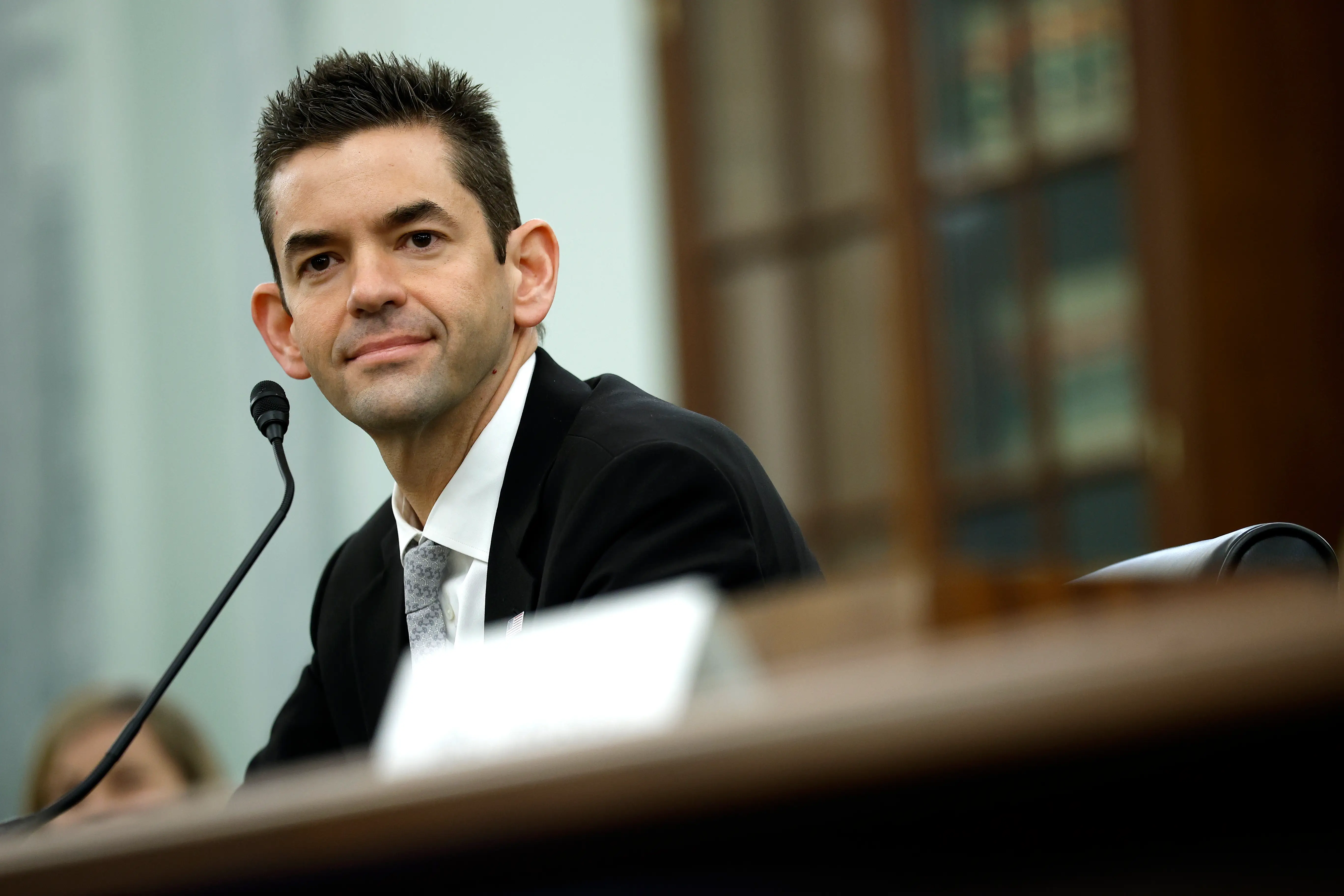 Jared Isaacman sitting in suit