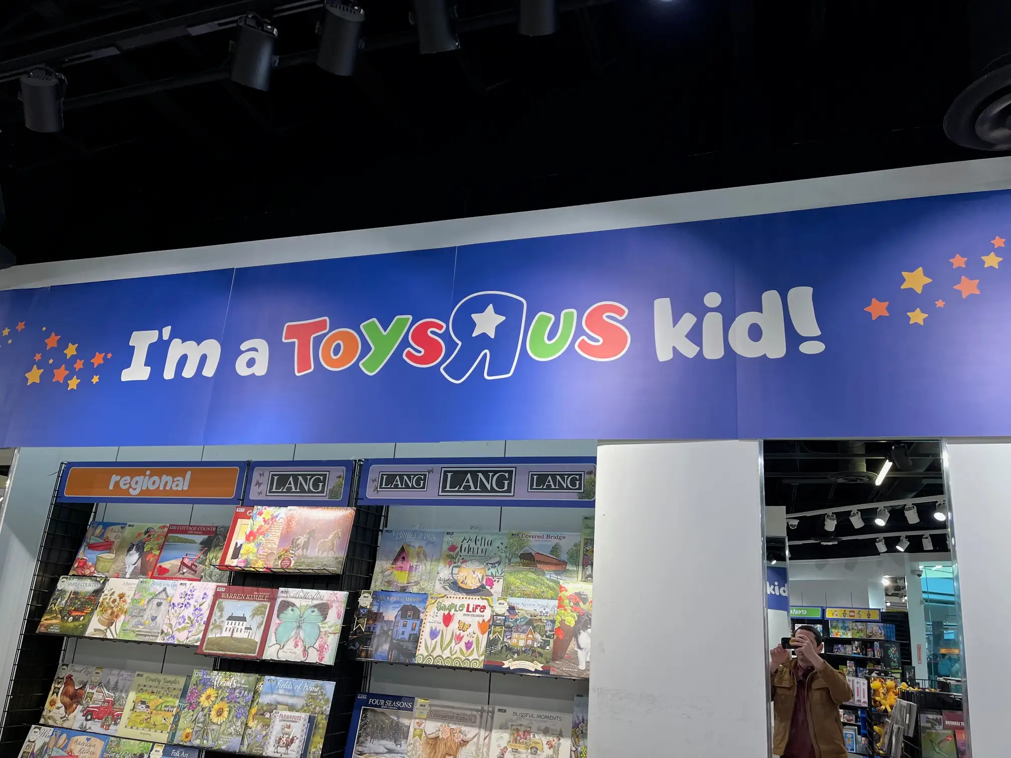 A banner above some calendars at Toys R Us reads: 