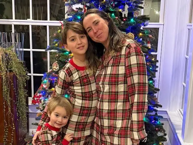 Mom and kids by Christmas tree