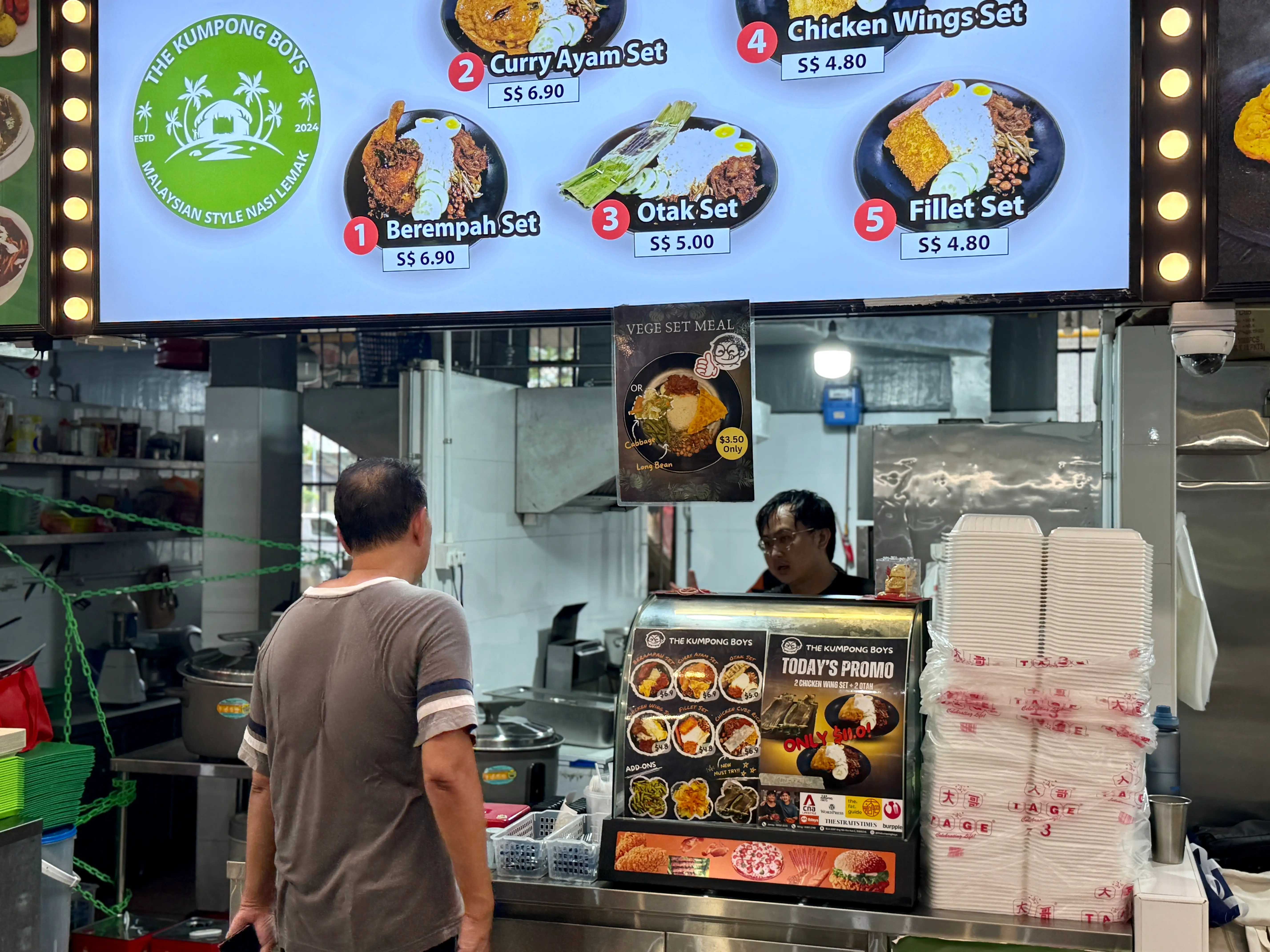 Koh serving a customer at his stall.