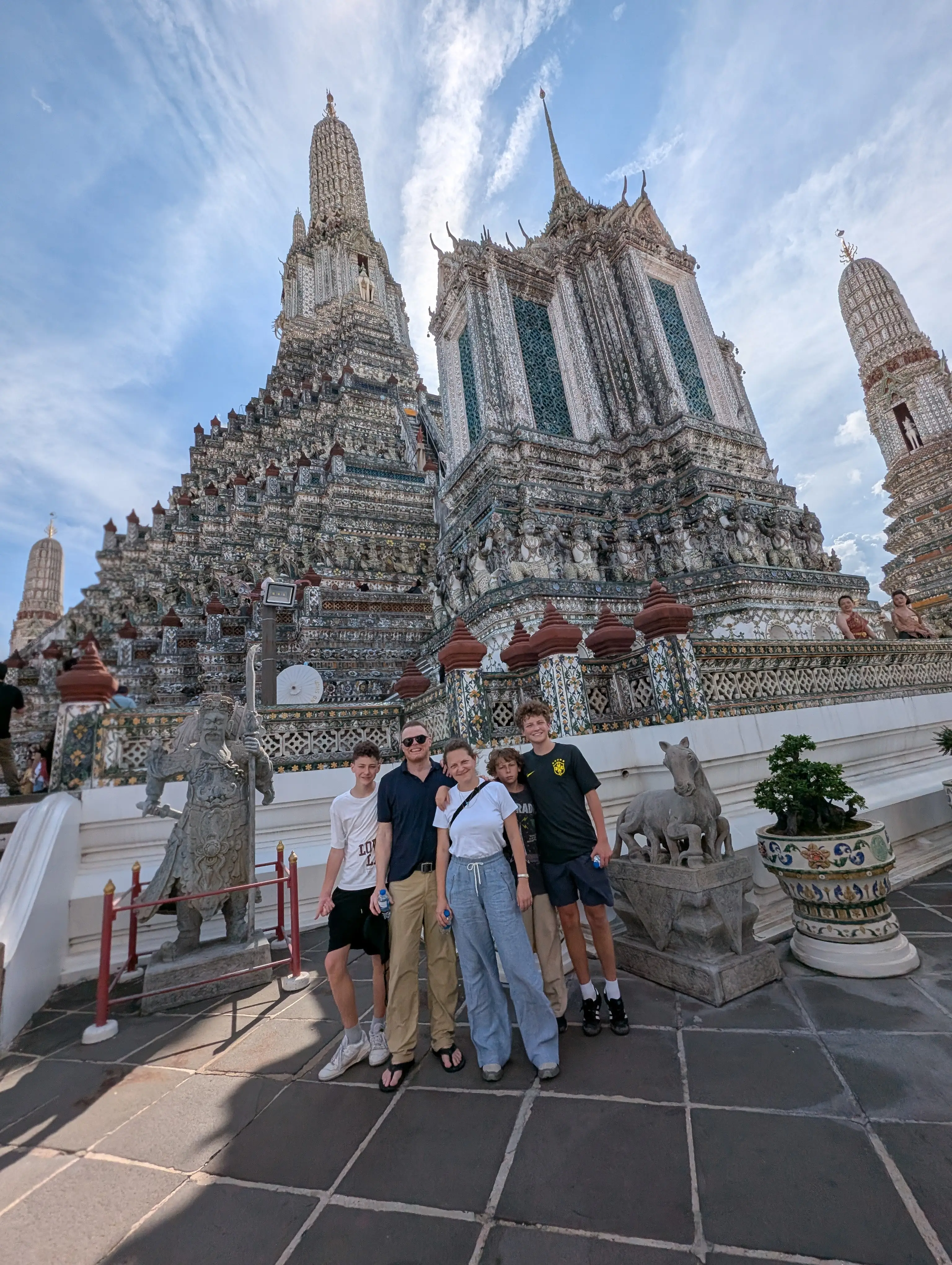 A photo of a family of five at a temple in Bangkok.