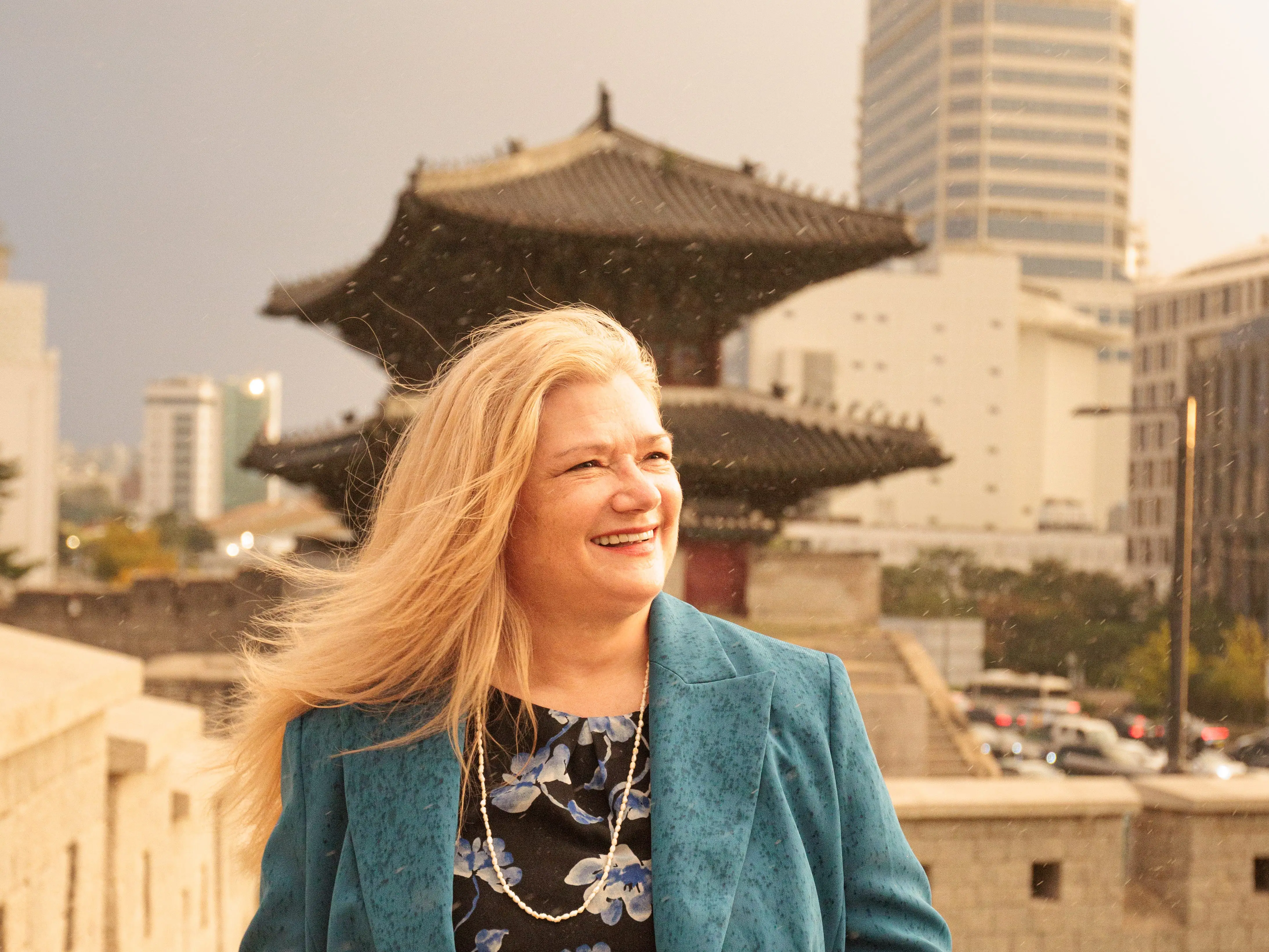 A woman posing in a blue blazer,