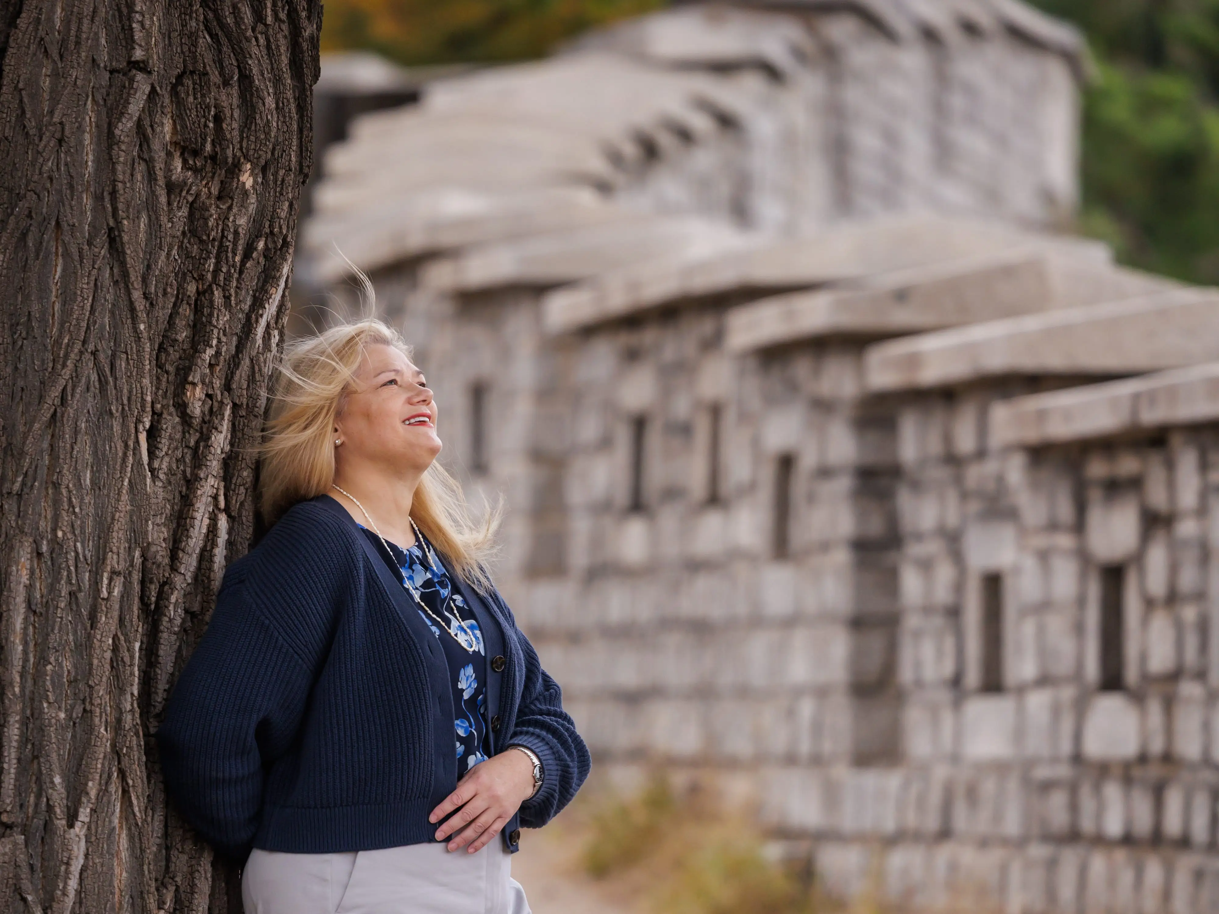 A woman leaning against a tree in South Korea.