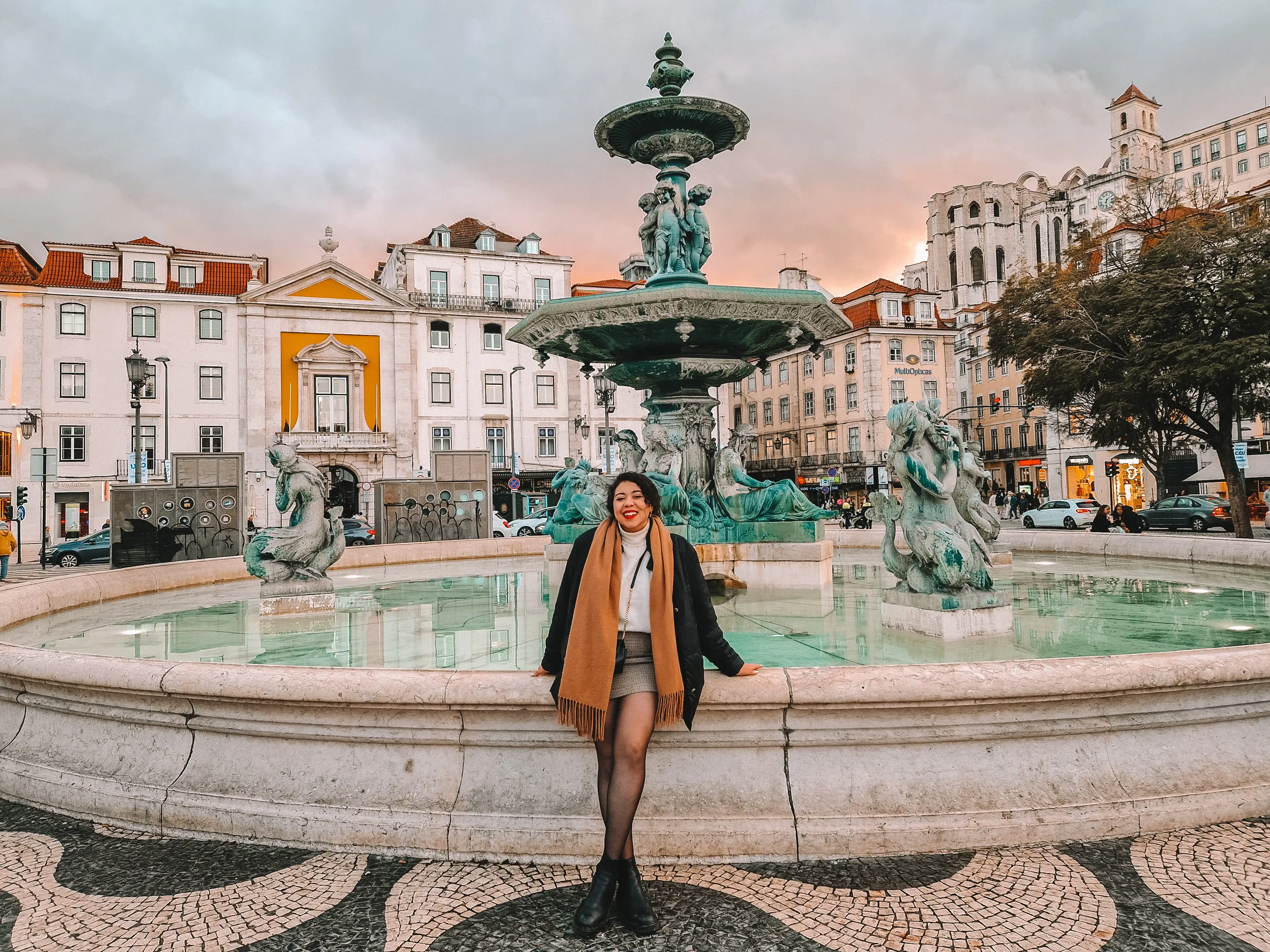 The author posing at a fountain in Lisbon.