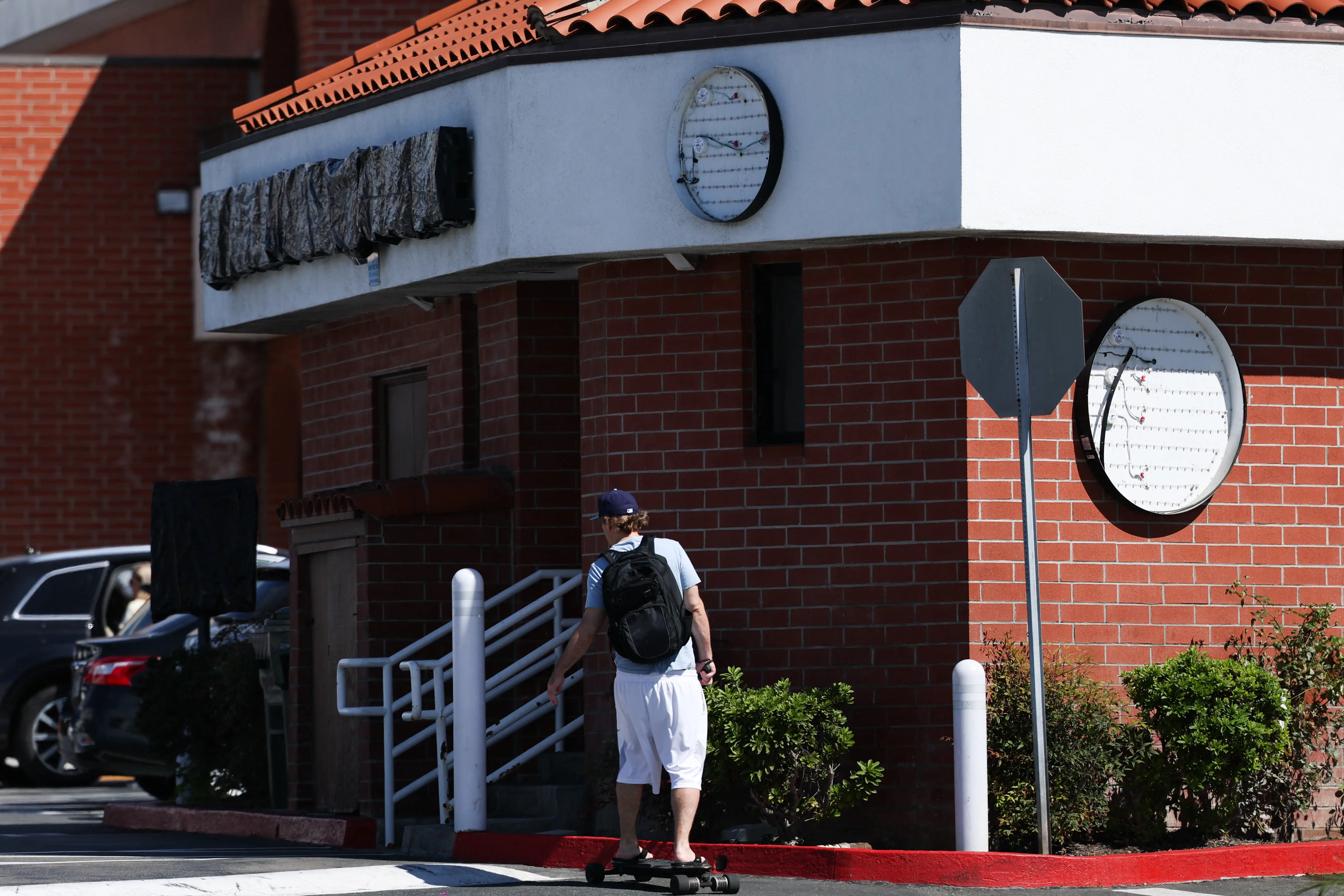 The exterior of a closed Starbucks store with its logos removed