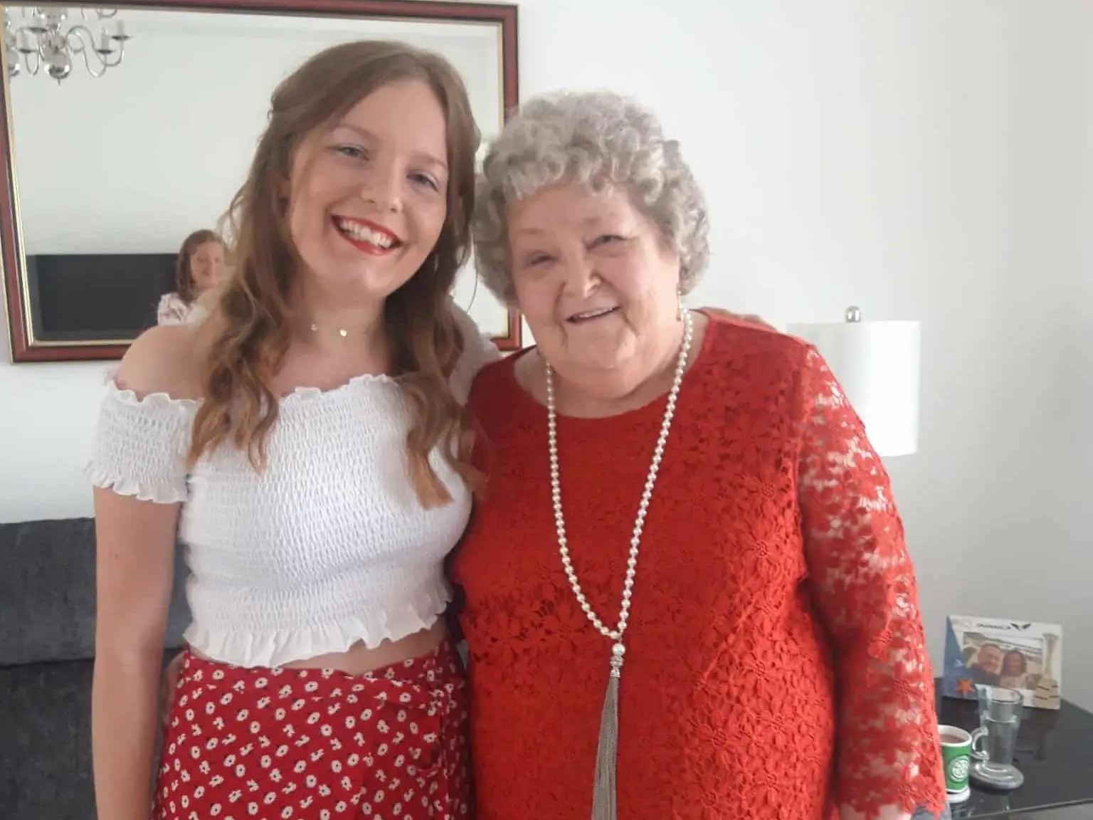 Granddaughter posing for photo with grandma