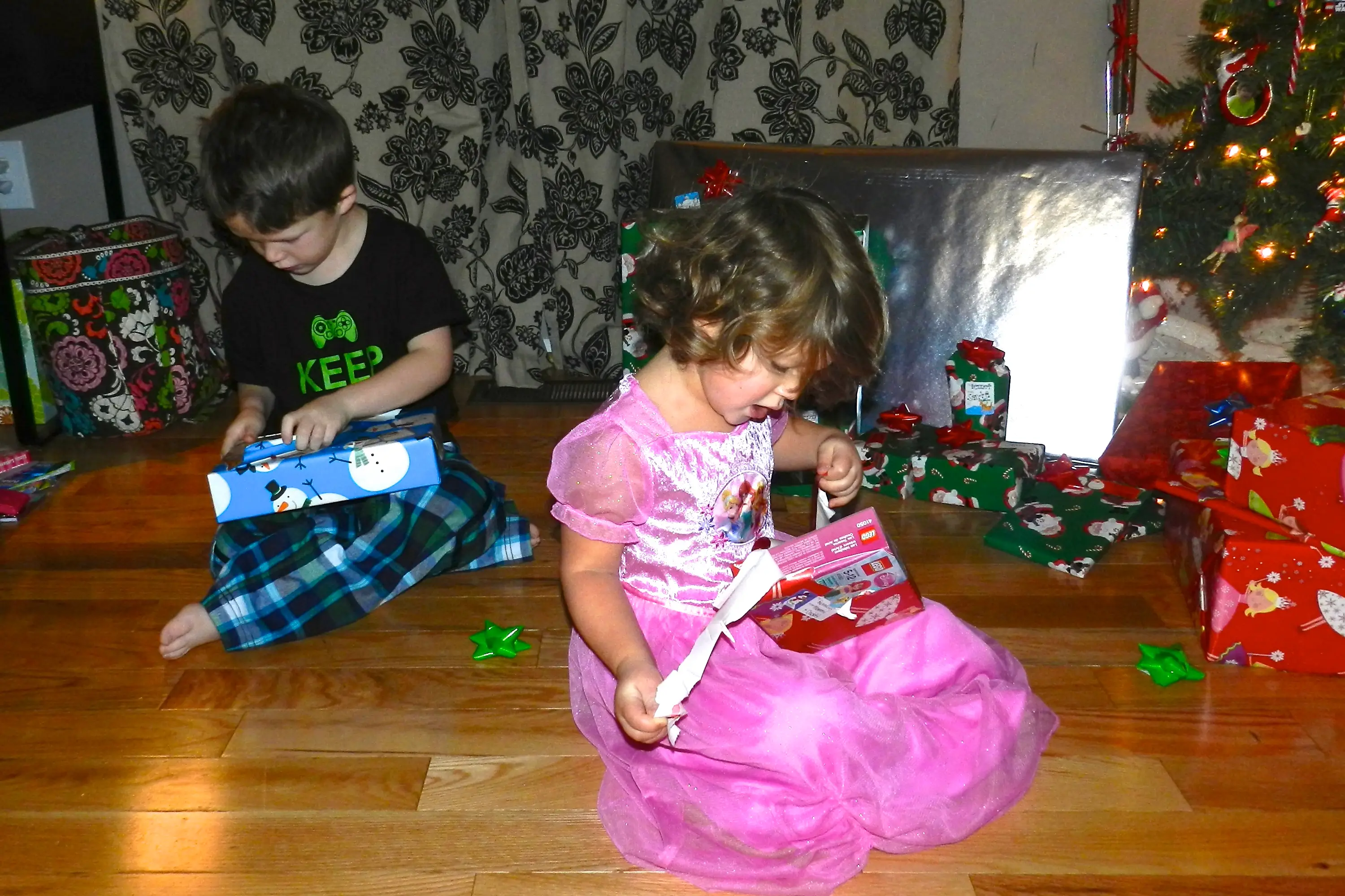 The author's kids opening gifts on Christmas when they were younger.
