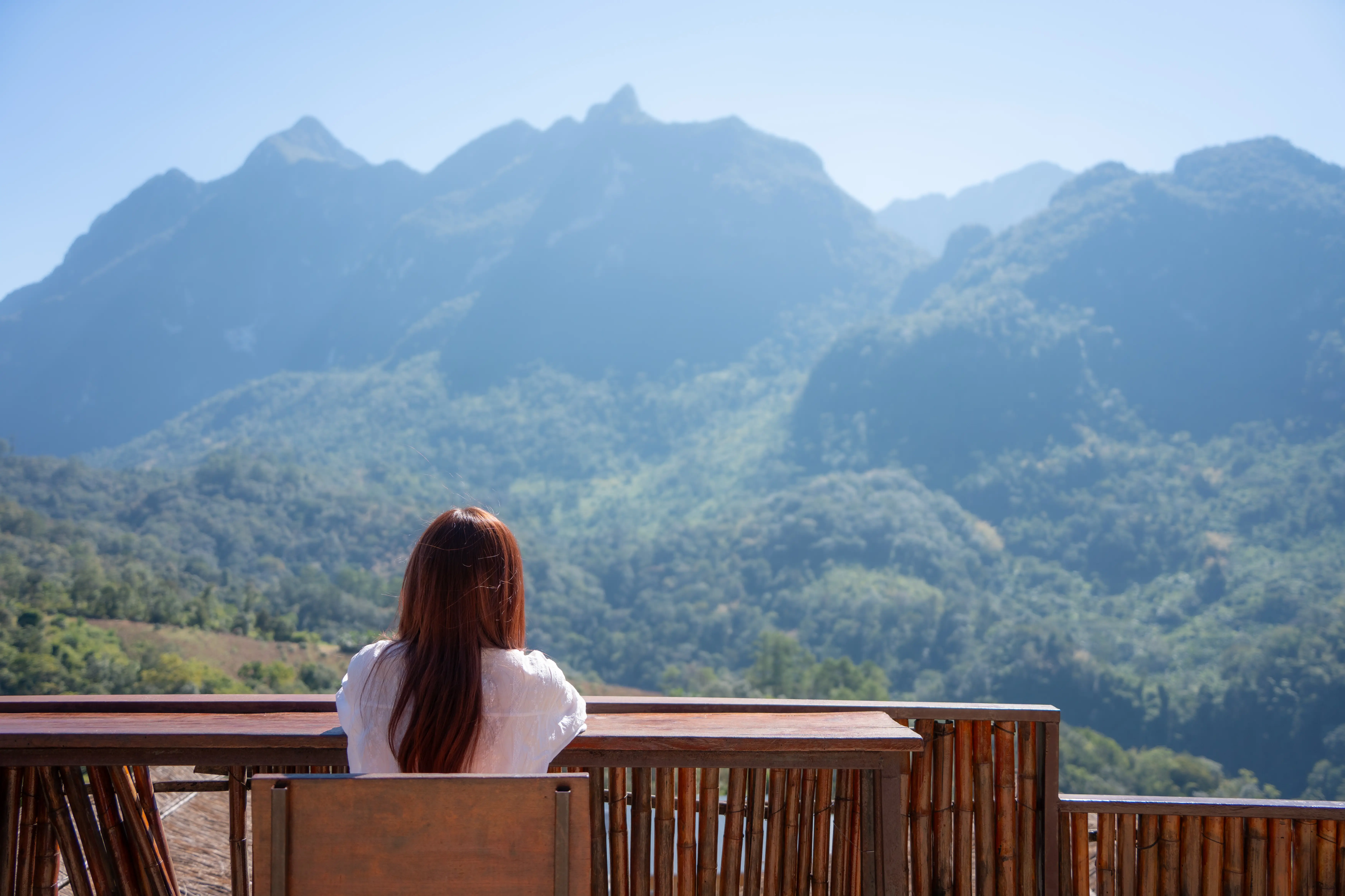 Woman looking out at mountains in Chiang Mai