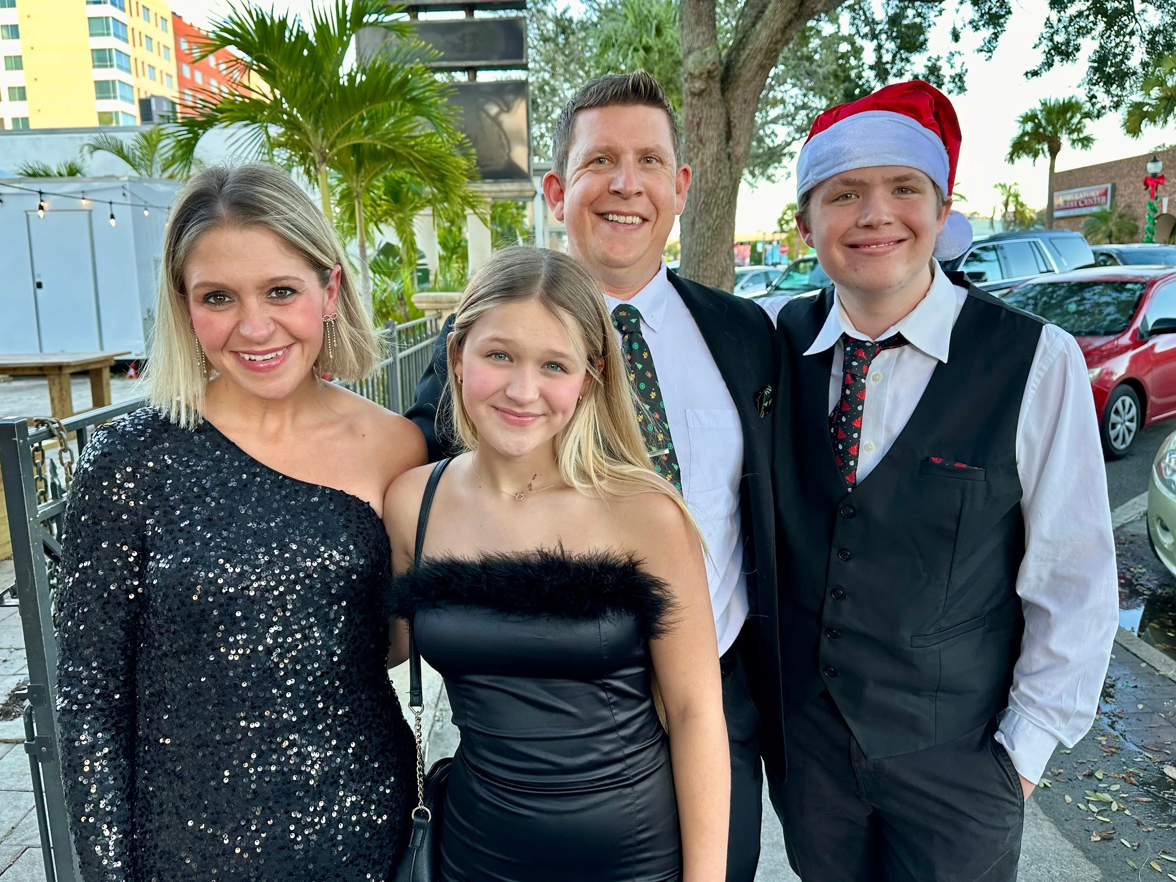 The author with her family going to a holiday dinner. They're all dressed up and smiling.